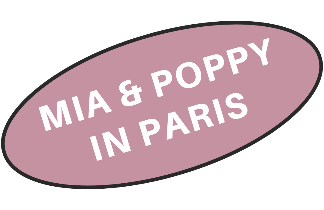 Pink oval sign with black outline that reads 'MIA & POPPY IN PARIS' in white text.