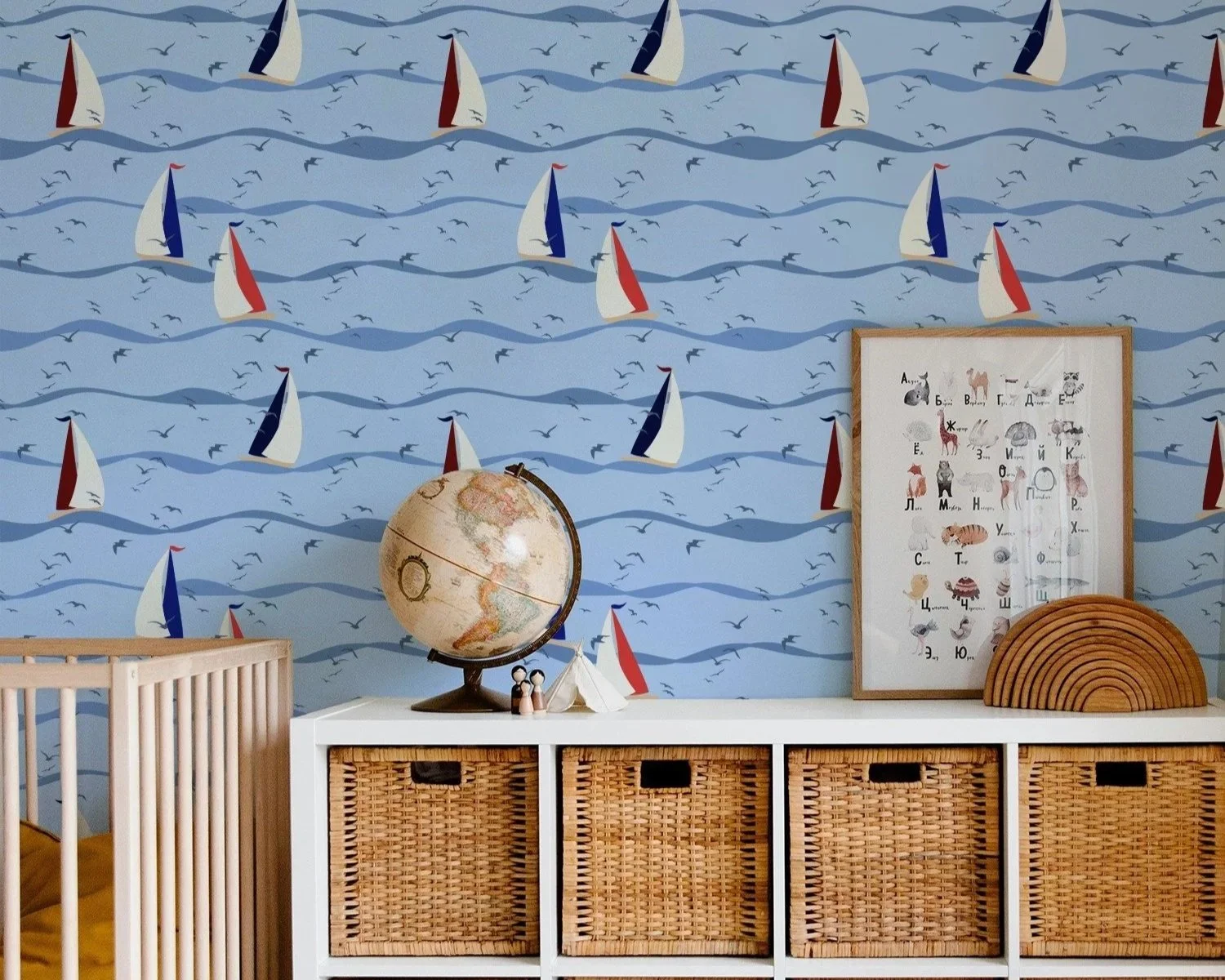 Sail Away Storybook Collection by Aitch Jay Designs — whimsical sailboat and wave repeat in red, white and blue, shown on a nursery feature wall to create a bright, imaginative coastal play space.