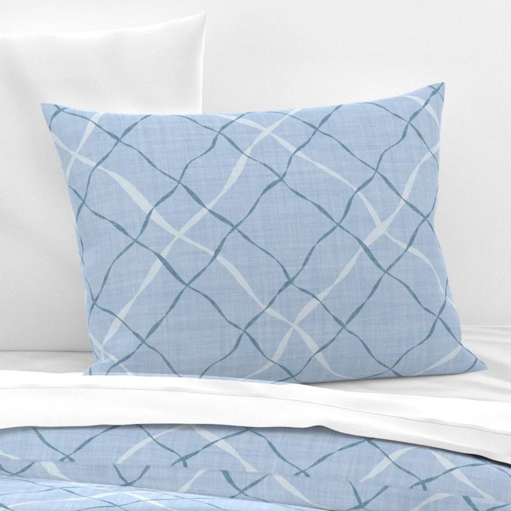 Ribbon Lattice by Aitch Jay Designs — light blue bedding with a flowing curved‑line lattice pattern, bringing a soft modern‑coastal feel to bedroom décor.
