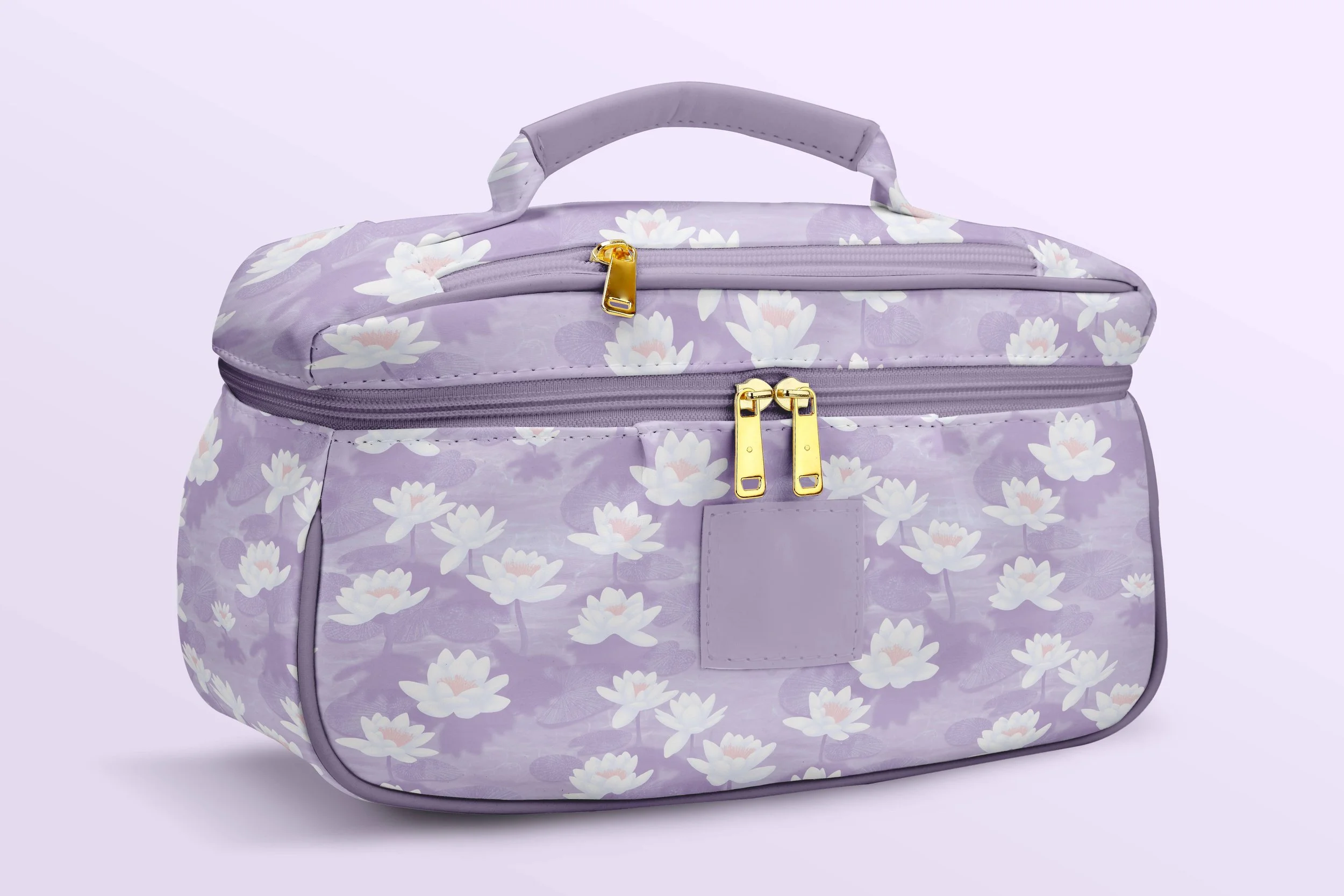 Lotus Blossom Drift by Aitch Jay Designs — lavender cosmetic bag with a soft lotus‑flower repeat, highlighting the delicate floral pattern.