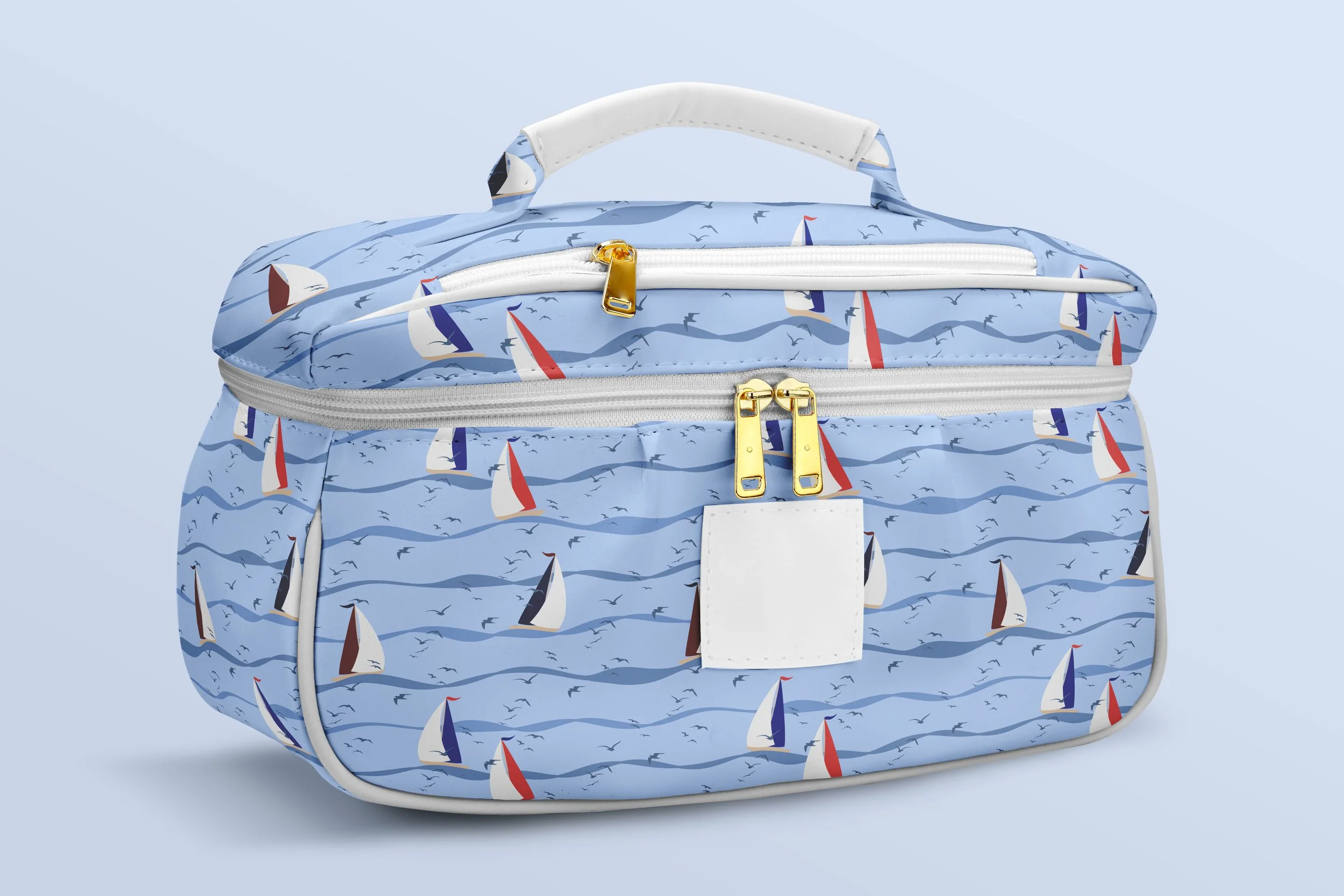 Sail Away Storybook Collection by Aitch Jay Designs — light blue sailboat and wave repeat with tiny seabirds, shown on a structured cosmetic travel bag to highlight cheerful nautical styling on toiletry bags and accessories.