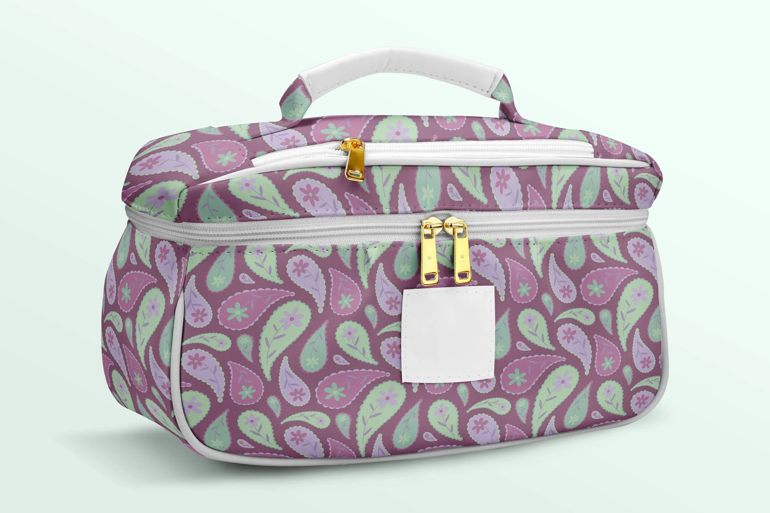 The Paisley Daisy pattern featuring delicate paisley curves and daisy florals in soft purple, green and pink, shown on an accessory - a make up / toiletry bag - to demonstrate scale and application
