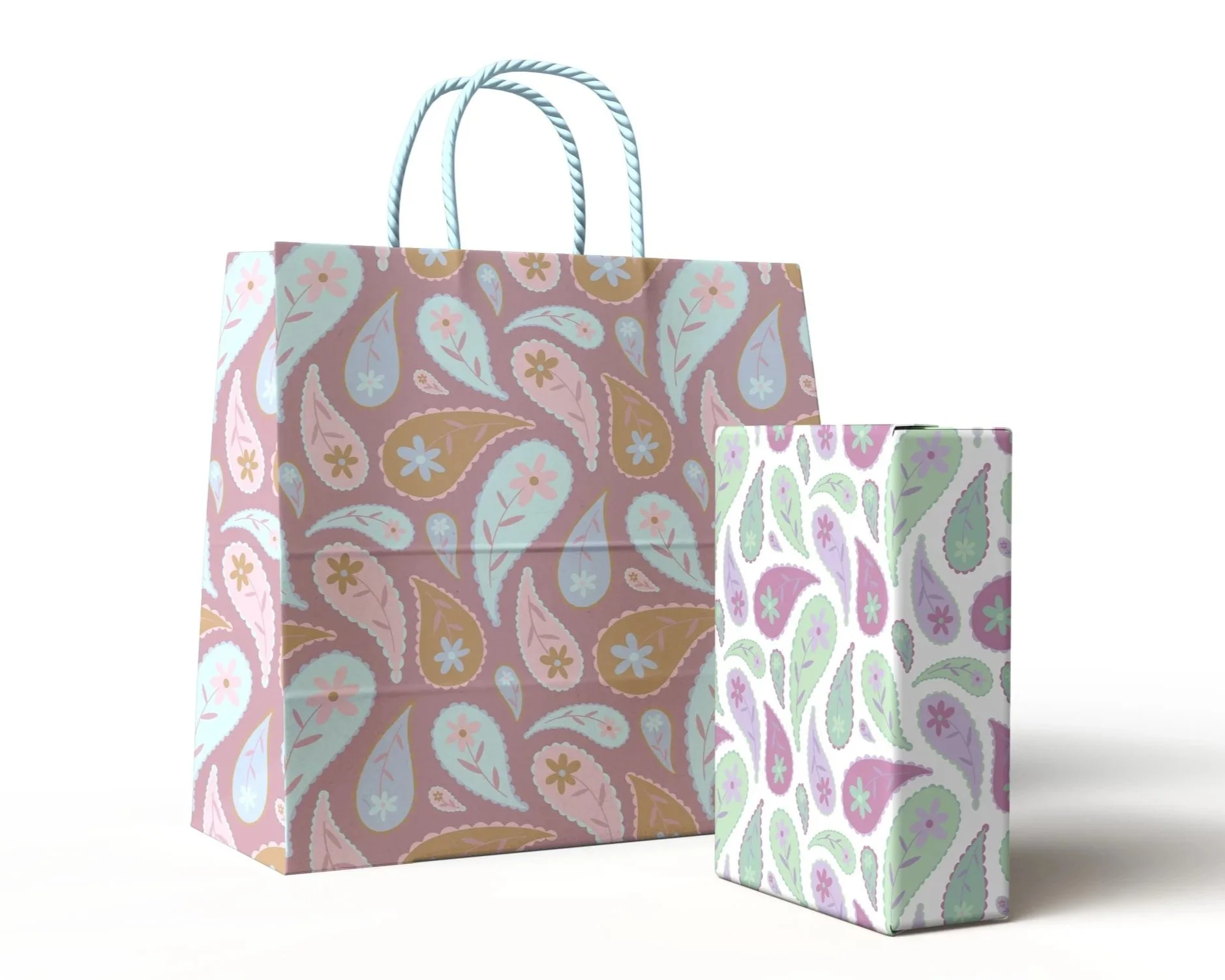 Two colorful shopping bags with floral and leaf patterns, one larger and pink, the other smaller and white, placed against a plain background.