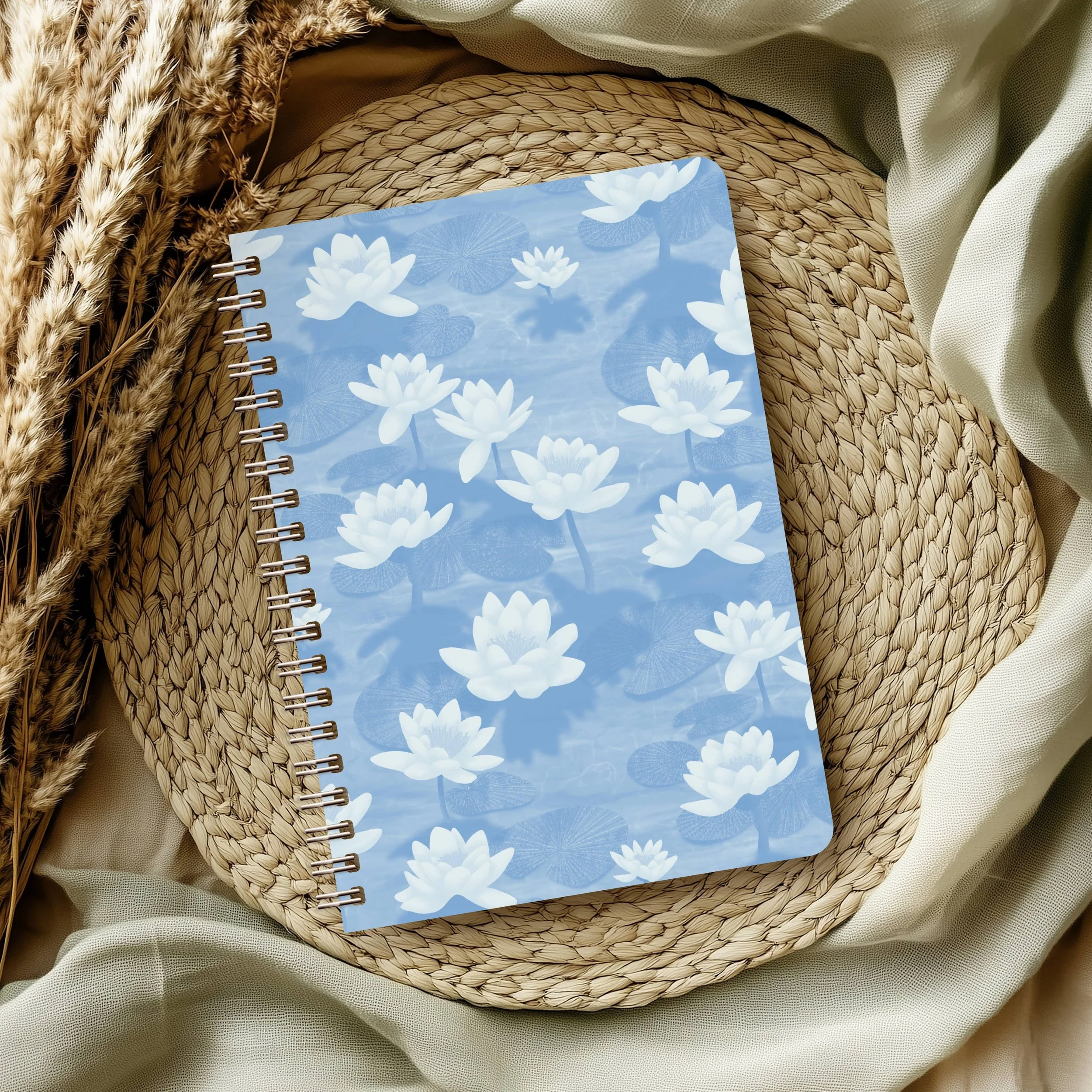 Lotus Blossom Drift by Aitch Jay Designs — a light blue lotus‑flower waterlily pattern on a notebook cover, showcasing the gentle, airy floral repeat.