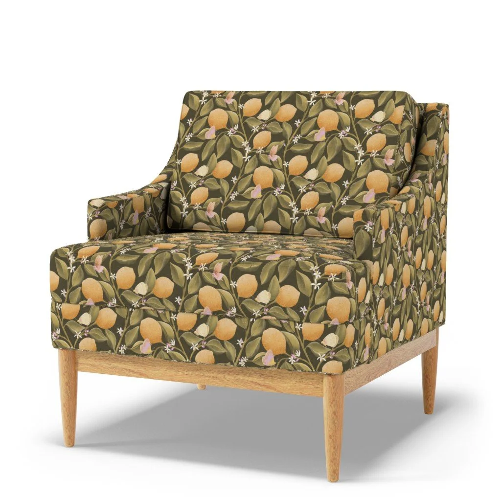 Armchair featuring the Lemon Tree Garden botanical pattern with hand‑drawn lemons, green leaves, blossoms, and butterflies, on an earthy dark green background, designed by Aitch Jay Designs.