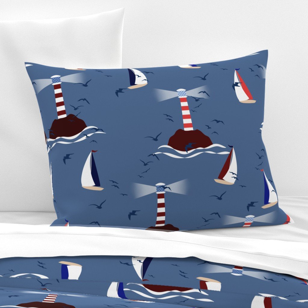 Sail Away Storybook Collection by Aitch Jay Designs — denim blue lighthouse and sailboat repeat with stylised waves and seabirds, shown on coastal bedding for a classic maritime look.