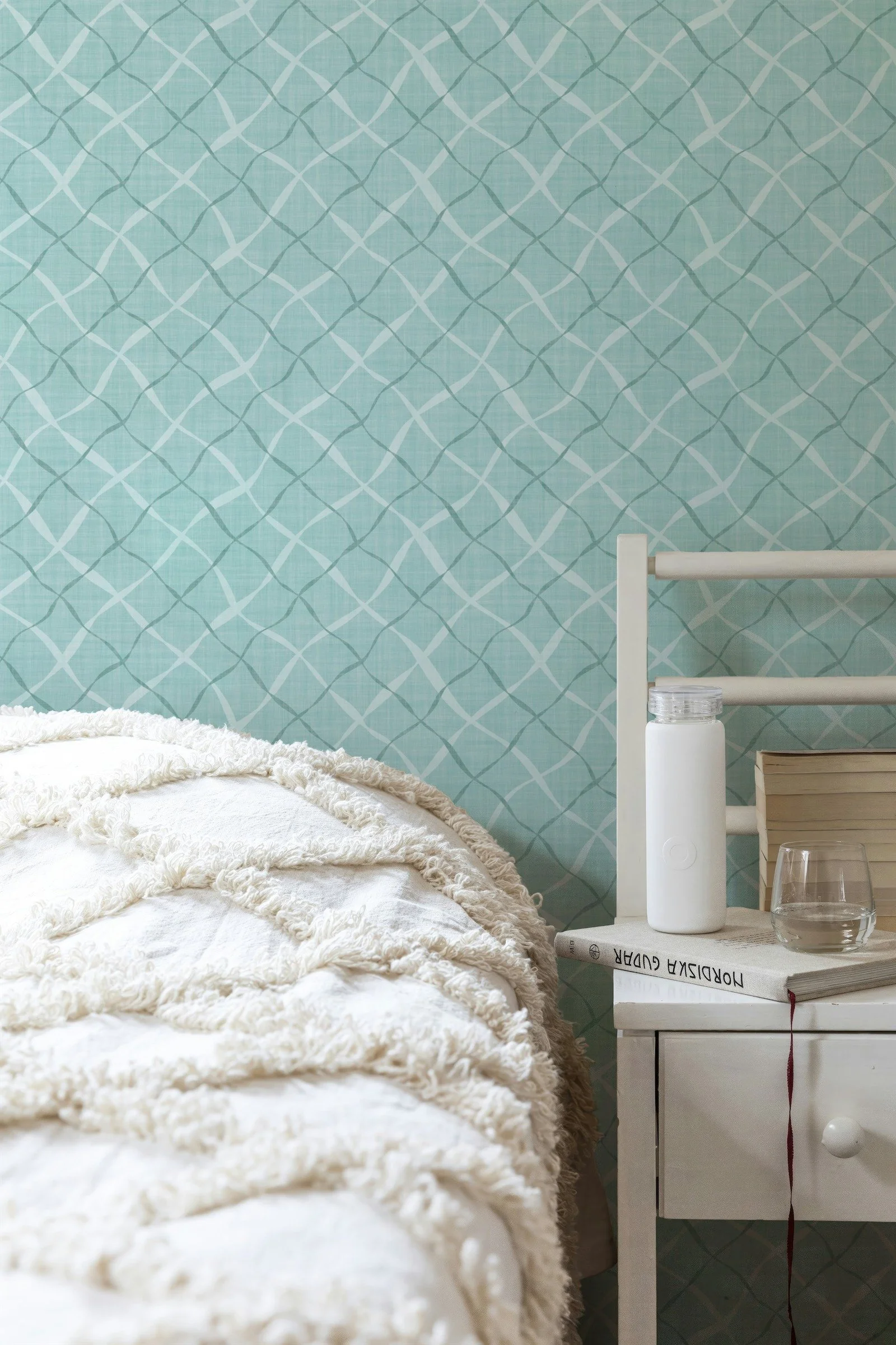Ribbon Lattice by Aitch Jay Designs — light aqua seafoam geometric lattice wallpaper with soft curved lines, creating a fresh modern‑coastal backdrop for serene bedroom styling.