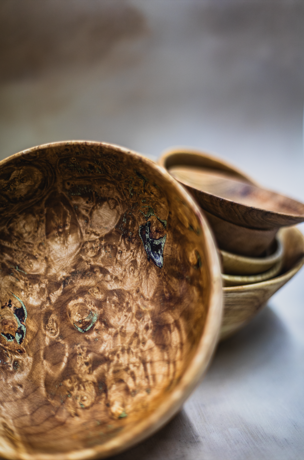 Various bowls. Bowl at front is maple burl with brass inlay. 2024-2025.