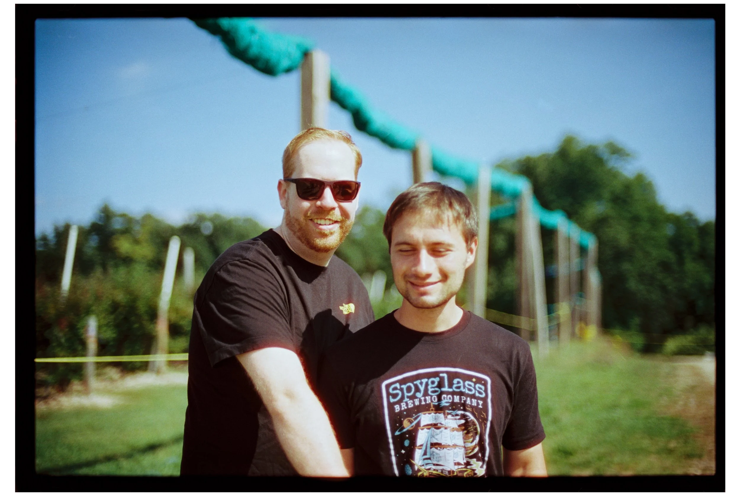 Ben and John. Apple picking. October 2025. New Hampshire. Nikon F3. CineStill 400D.