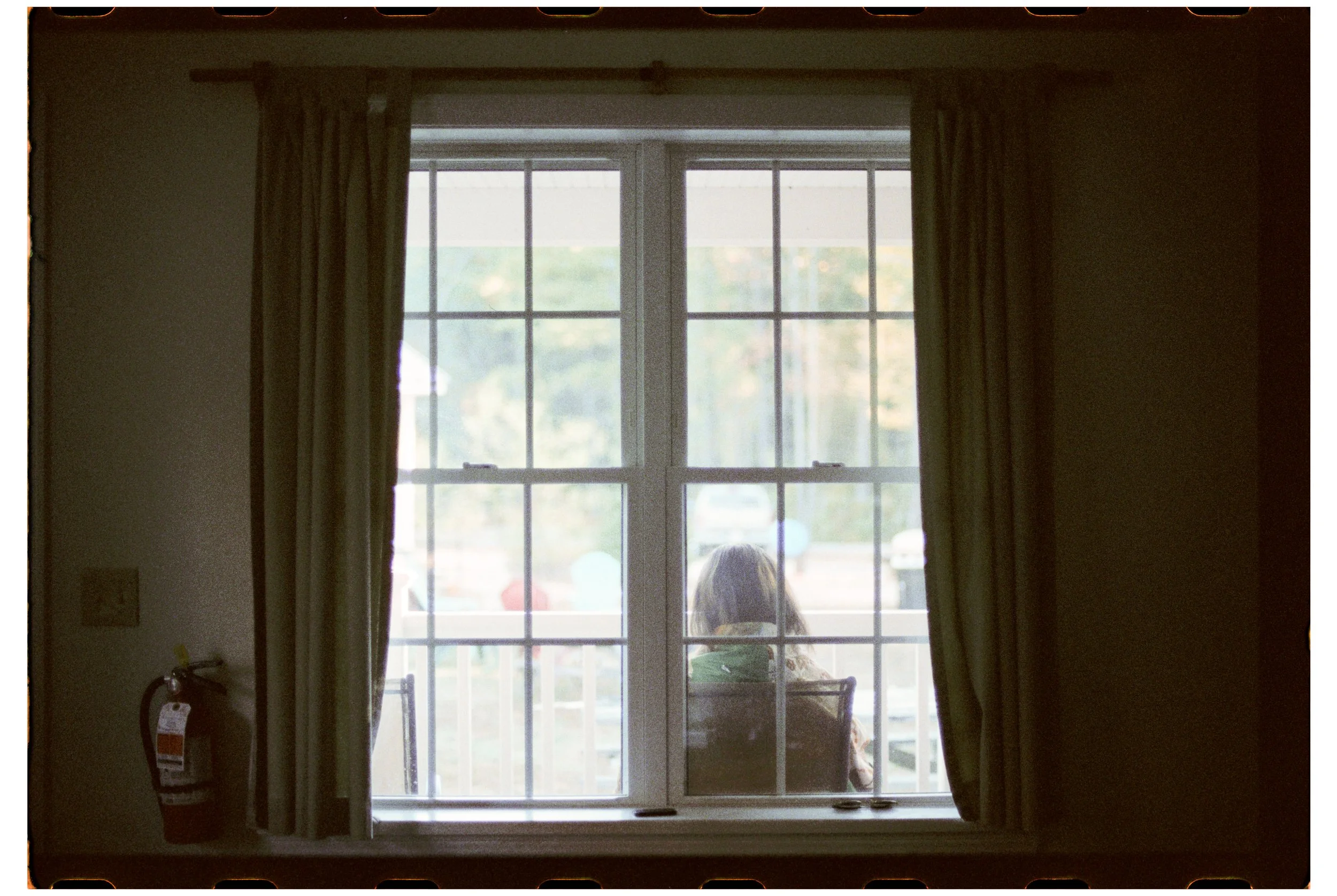 Becca reads outside the cabin in the morning.  Camp Calumet. Freedom, NH. October 2025.