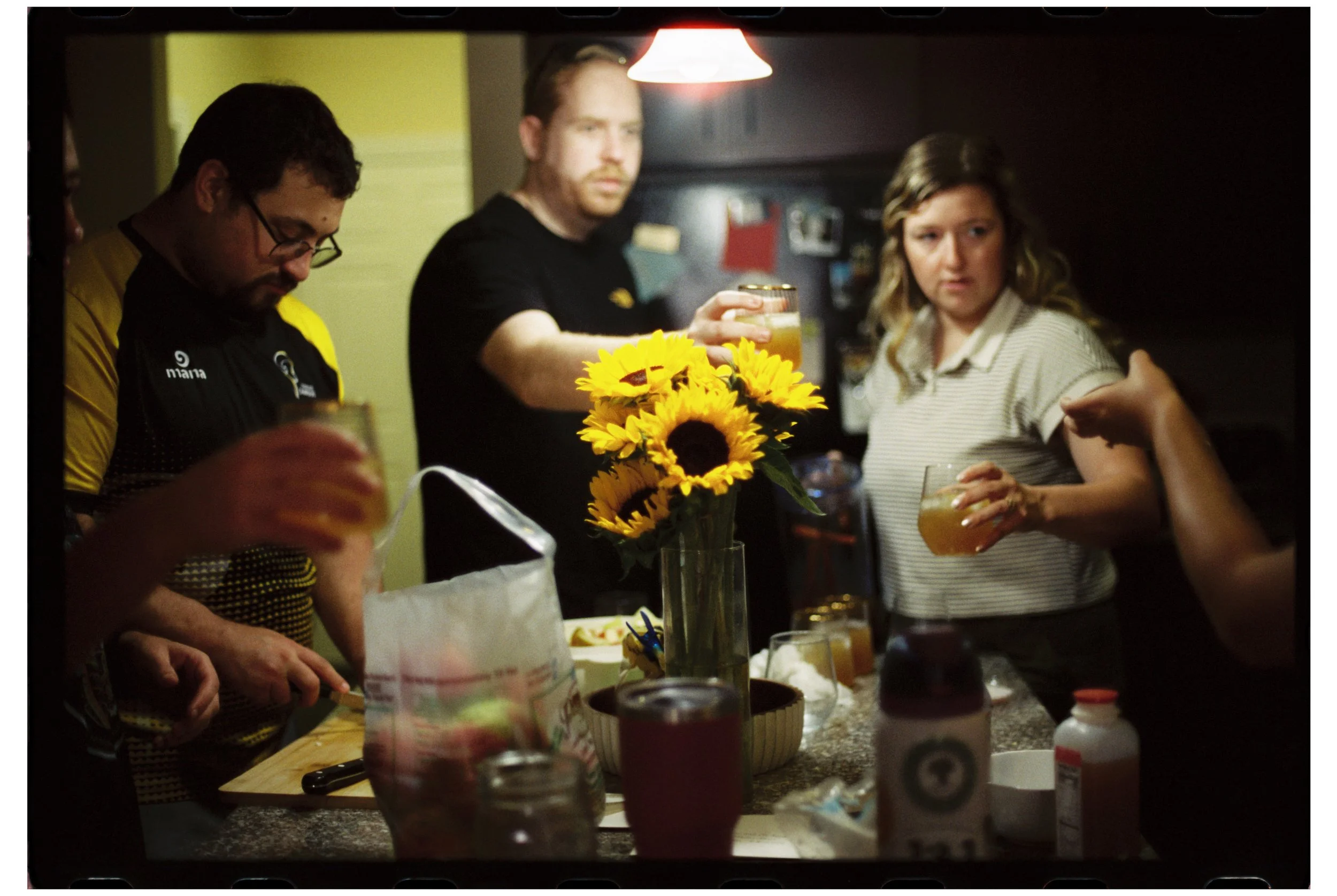 Drinks with friends at Ben and Michelle's. October 2025. New Hampshire. Nikon F3. CineStill 400D.