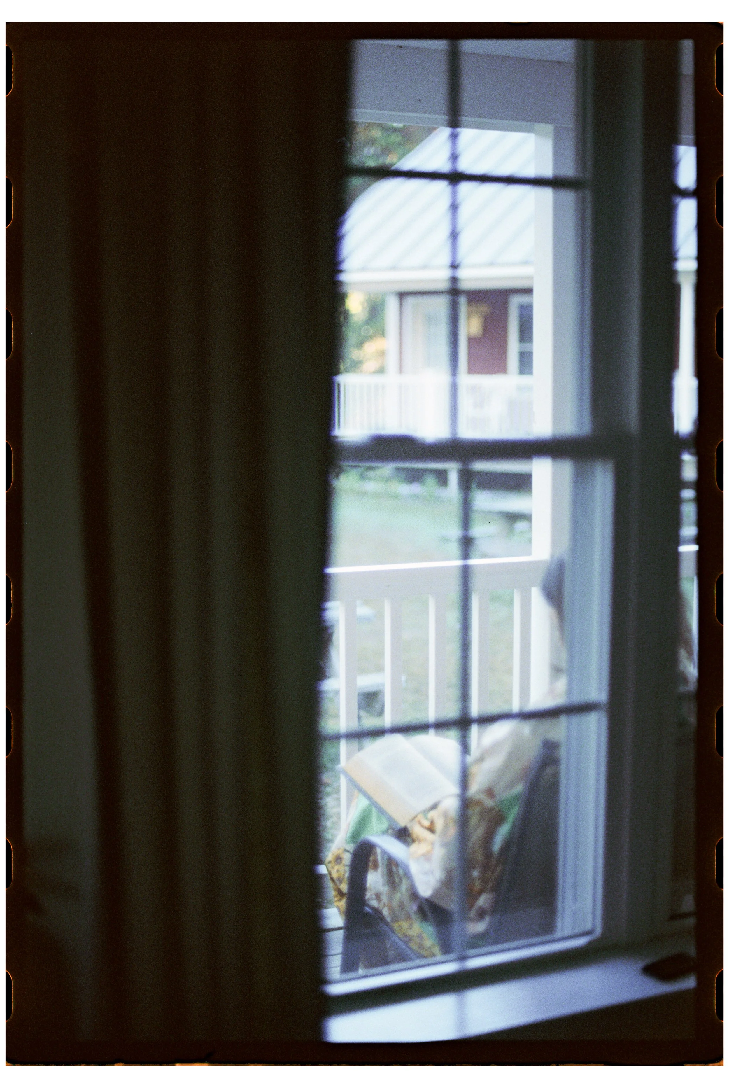 Becca reads outside the cabin in the morning.  Camp Calumet. Freedom, NH. October 2025.
