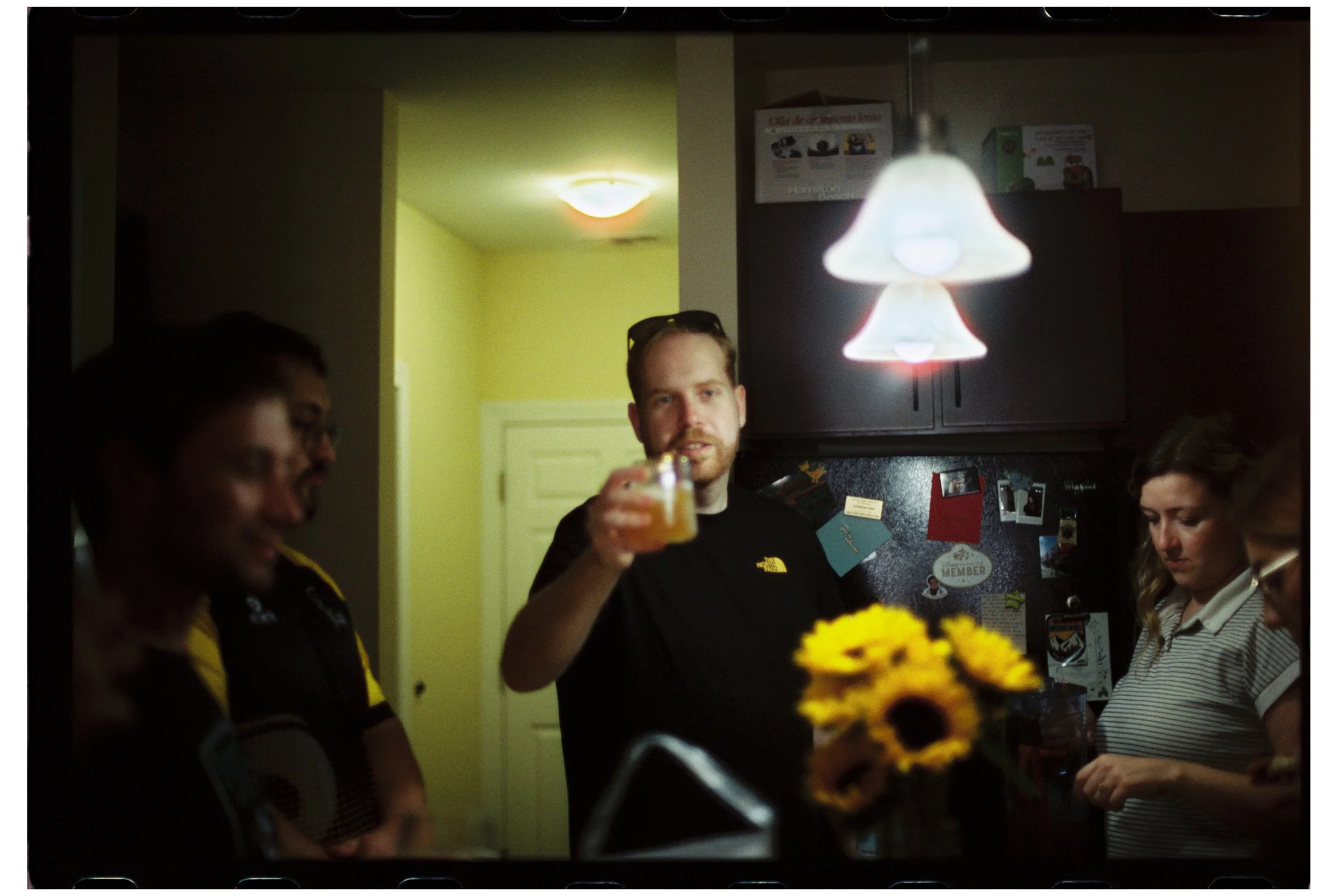 Drinks with friends at Ben and Michelle's. October 2025. New Hampshire. Nikon F3. CineStill 400D.