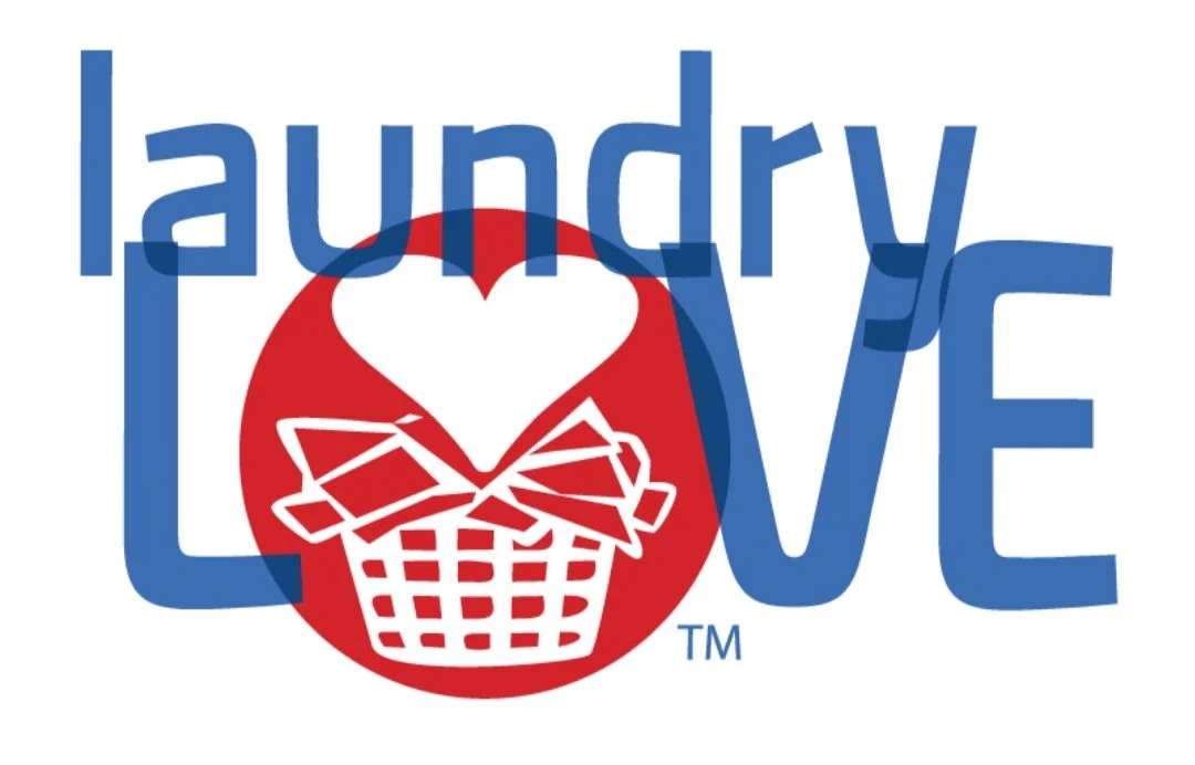 Graphic design of the words 'laundry love' with a red circle containing a white laundry basket with a heart above it.
