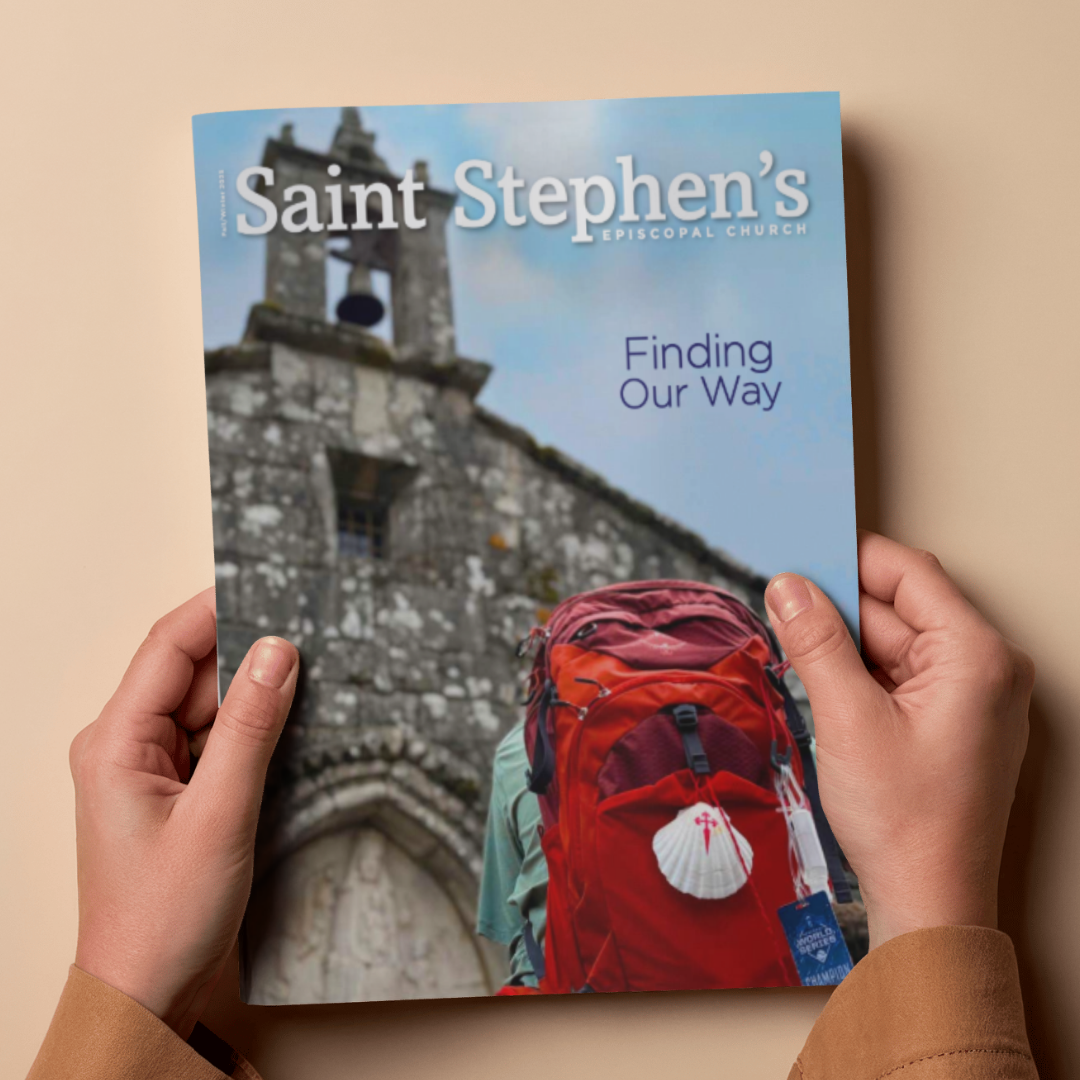 A person holding a brochure for Saint Stephen's Episcopal Church with the title 'Finding Our Way', showing a stone church and a person with a red backpack.