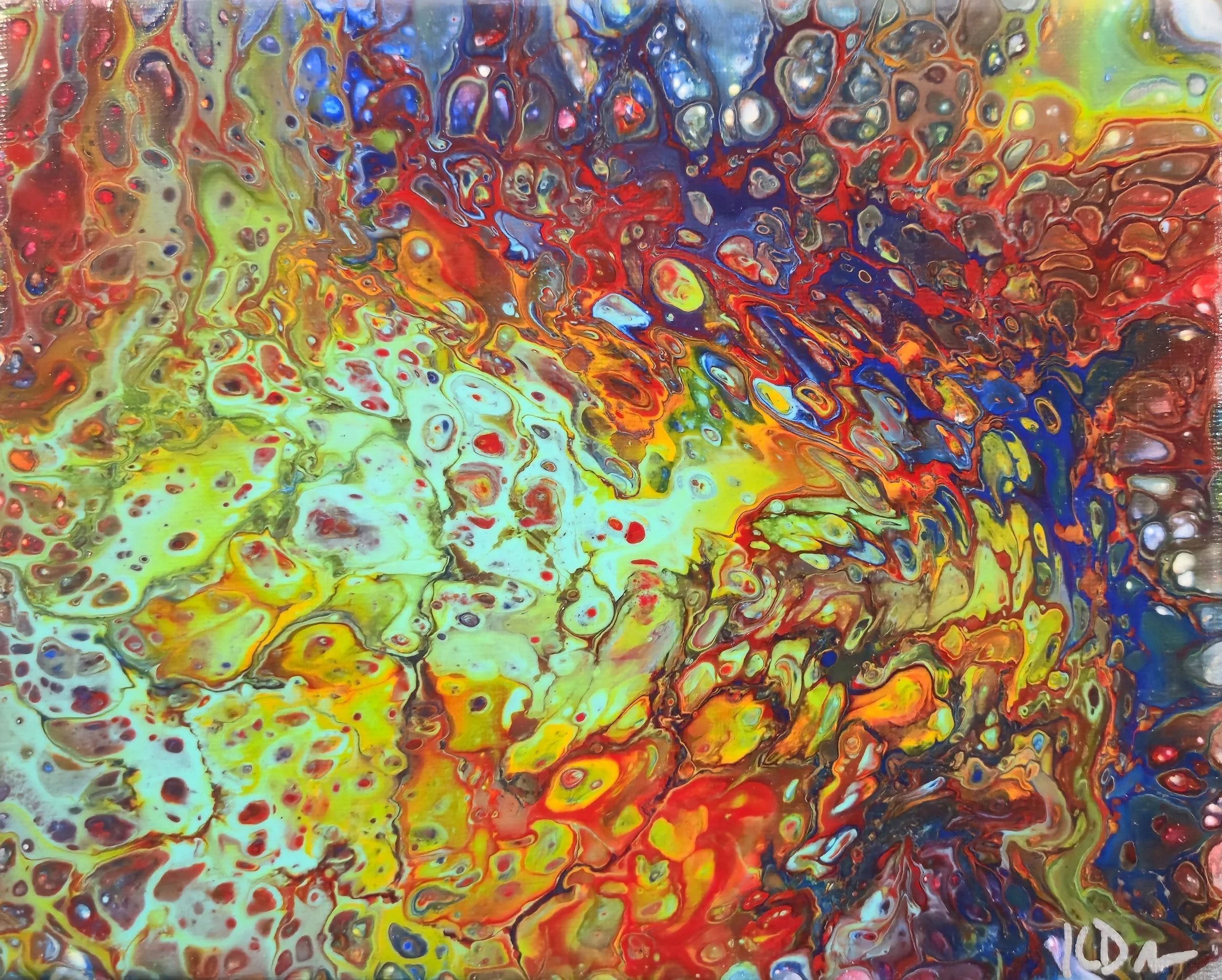 Abstract painting with vibrant splash of colors including yellow, red, blue, green, purple, and brown, creating a chaotic and dynamic pattern.