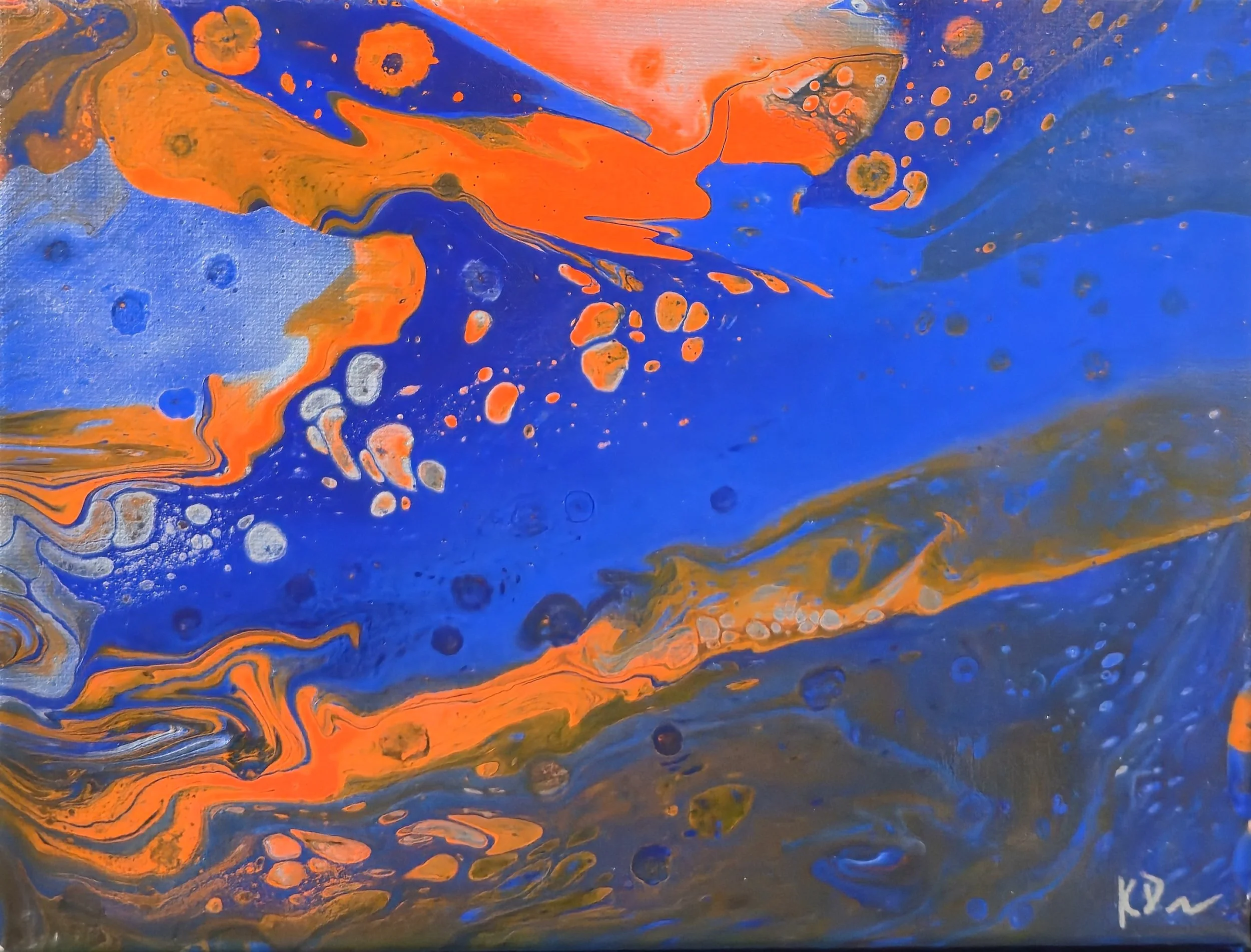 Abstract painting with swirling blue, orange, and gold colors, featuring scattered circular patterns.