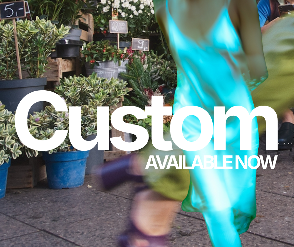 People shopping at a plant nursery or garden center with potted plants and flowers on display. The text overlay says 'Custom Available Now'.