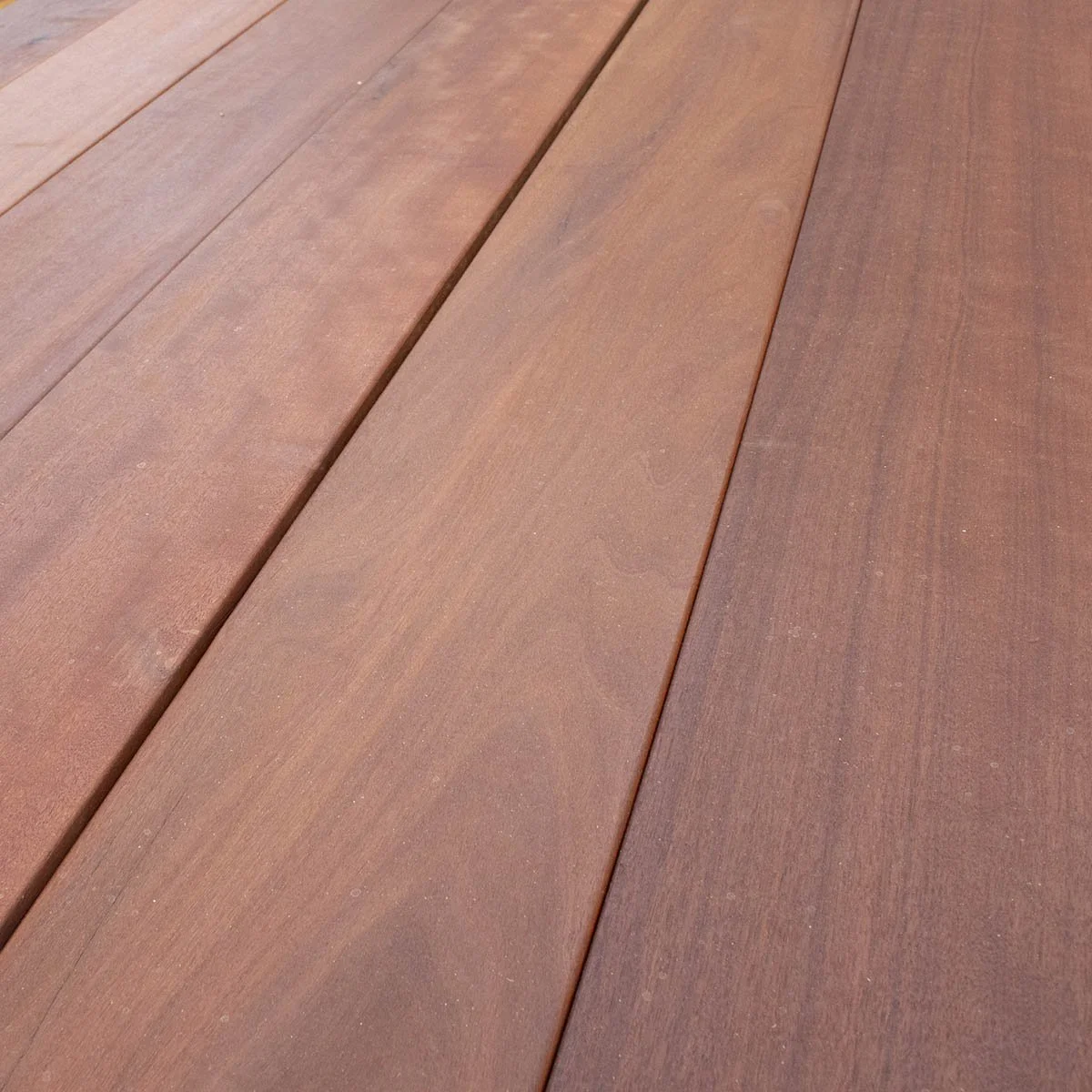 Close-up of reddish-brown wooden planks arranged in parallel.