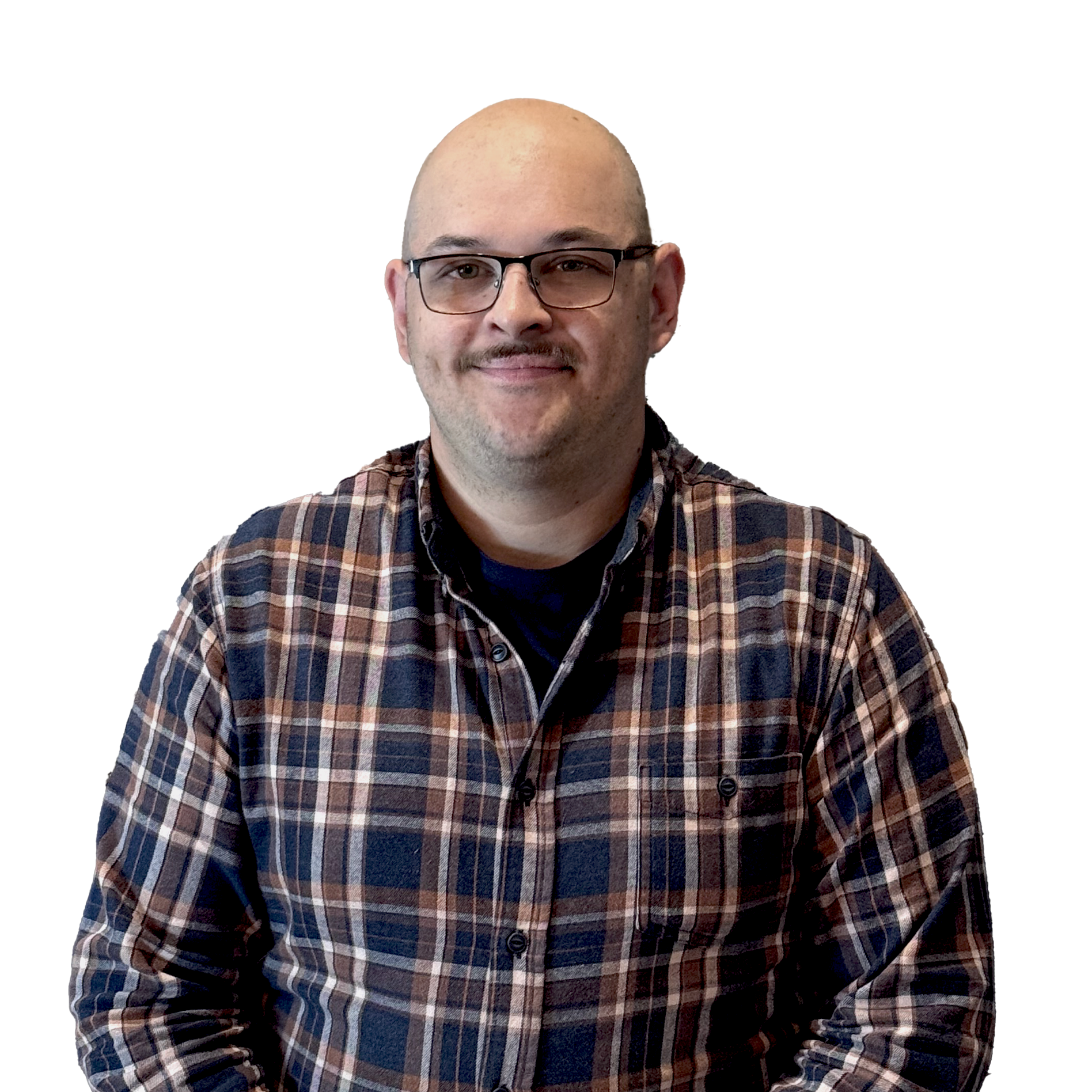 A man with a shaved head, glasses, and facial hair wearing a checkered shirt, smiling at the camera.