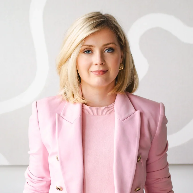 A woman with blonde hair smiling at the camera