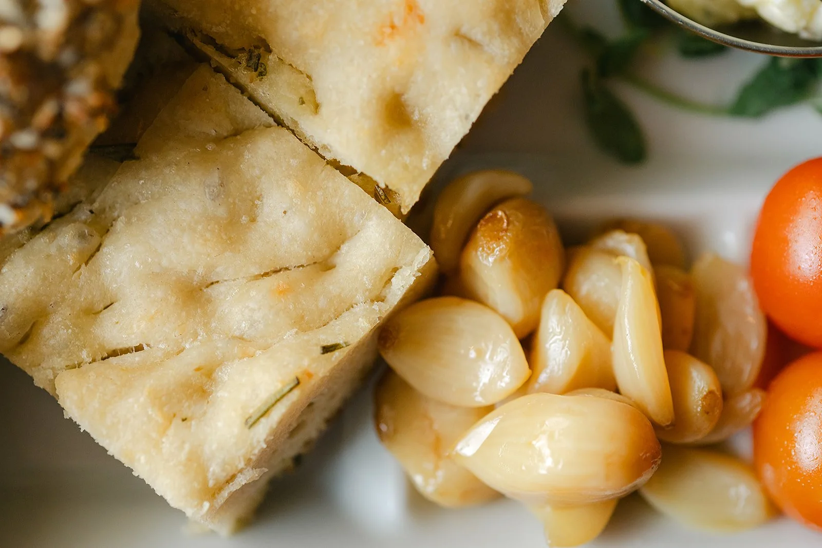 Close up of focaccia and garlic confit.