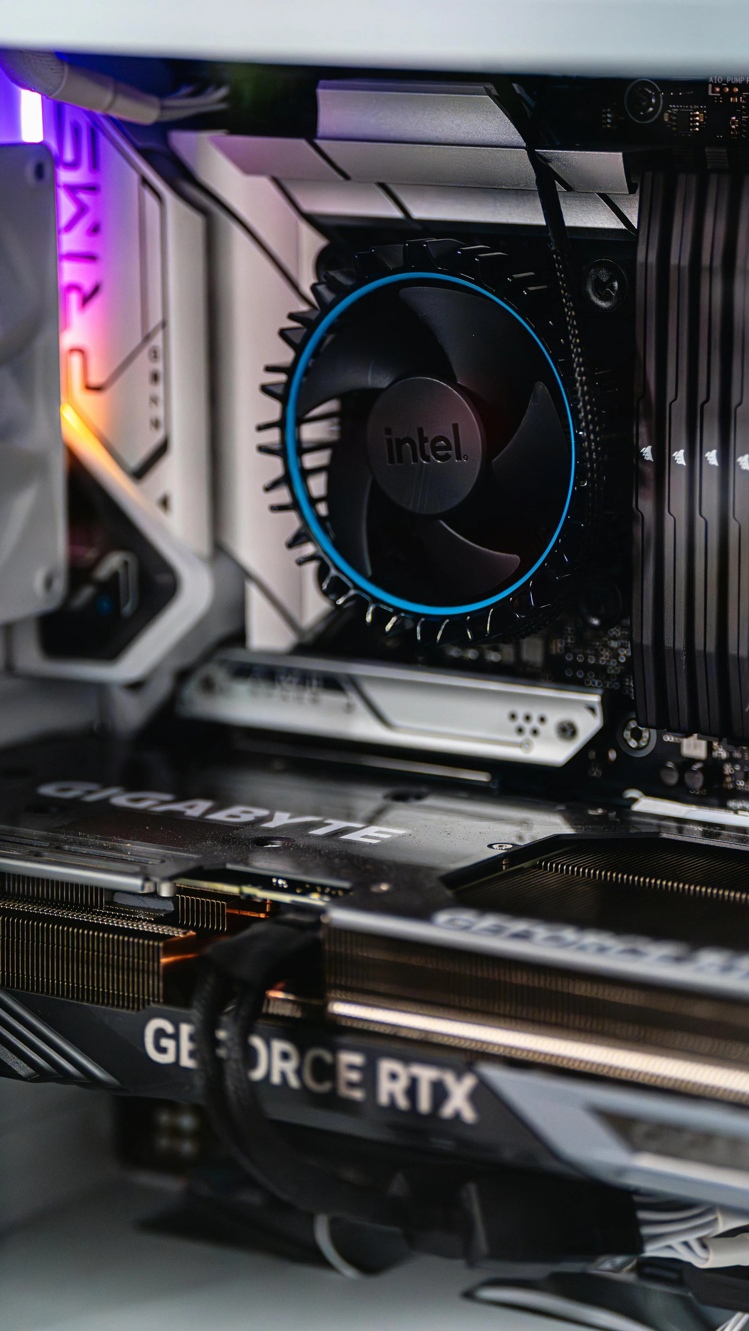 Close-up of a computer's interior showing a cooling fan, a graphics card labeled 'GEFORCE RTX', and various internal components.