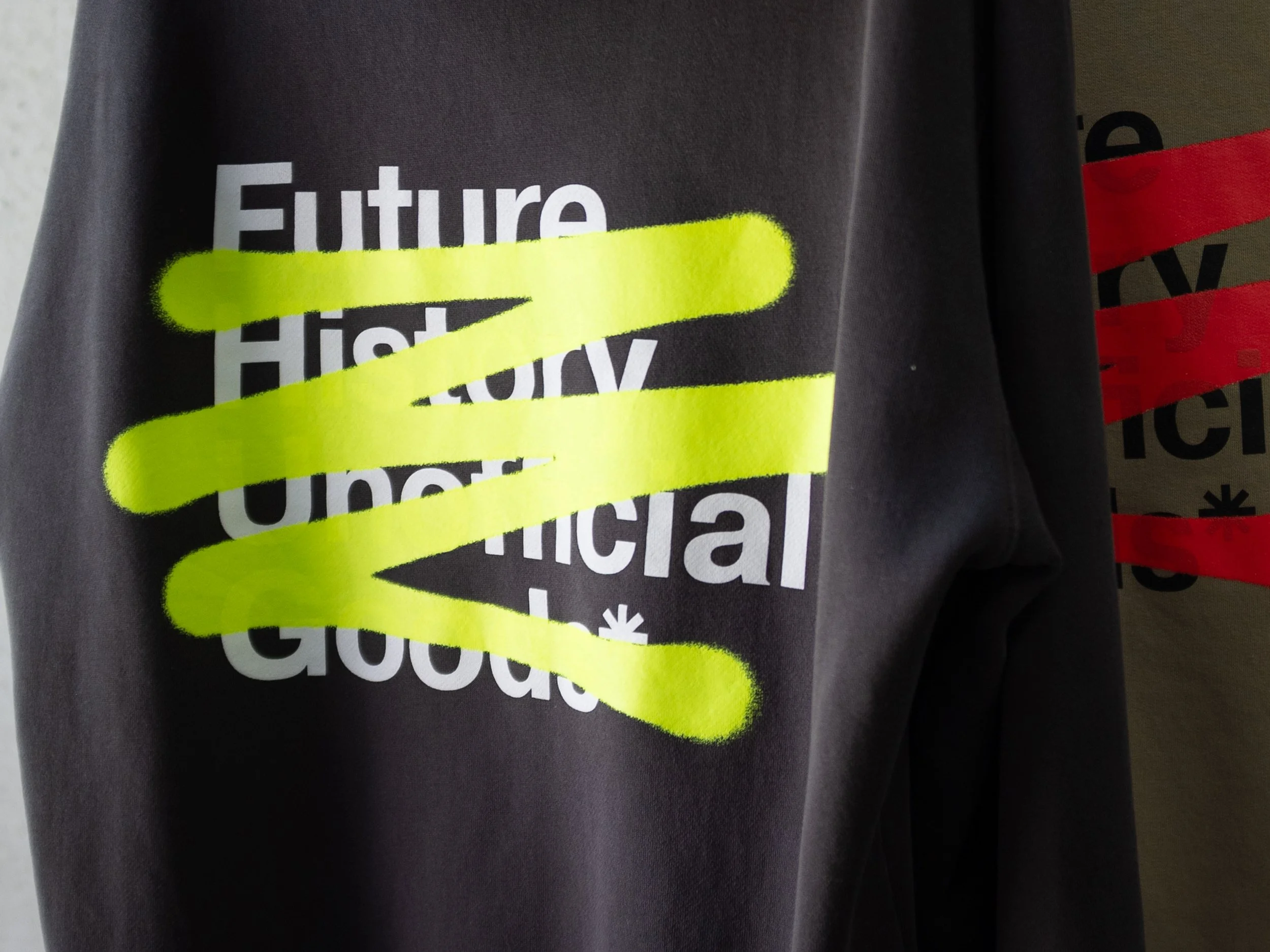 Black hoodie with white text that says 'Future High School Unofficial' and four yellow spray-painted lines across the text.