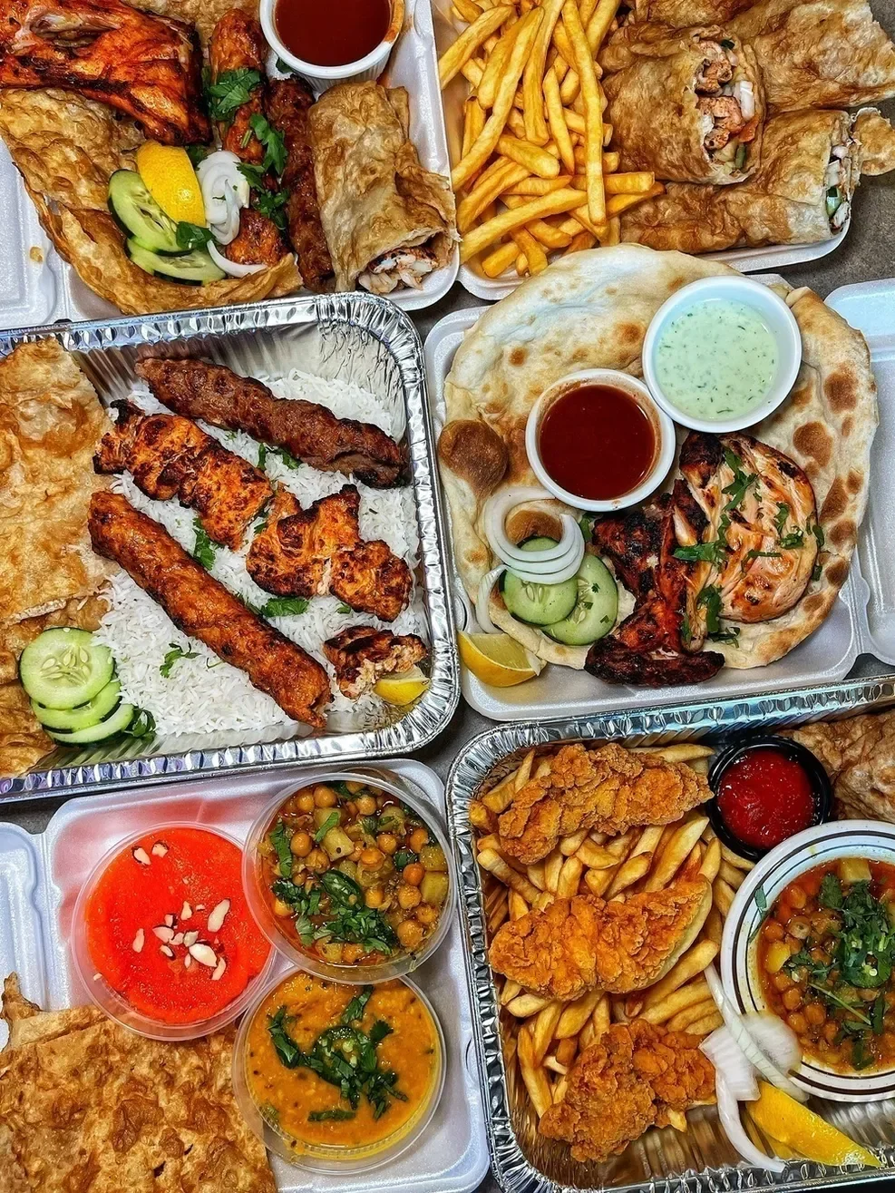 A variety of Indian and Pakistani dishes including grilled meats, and naan bread