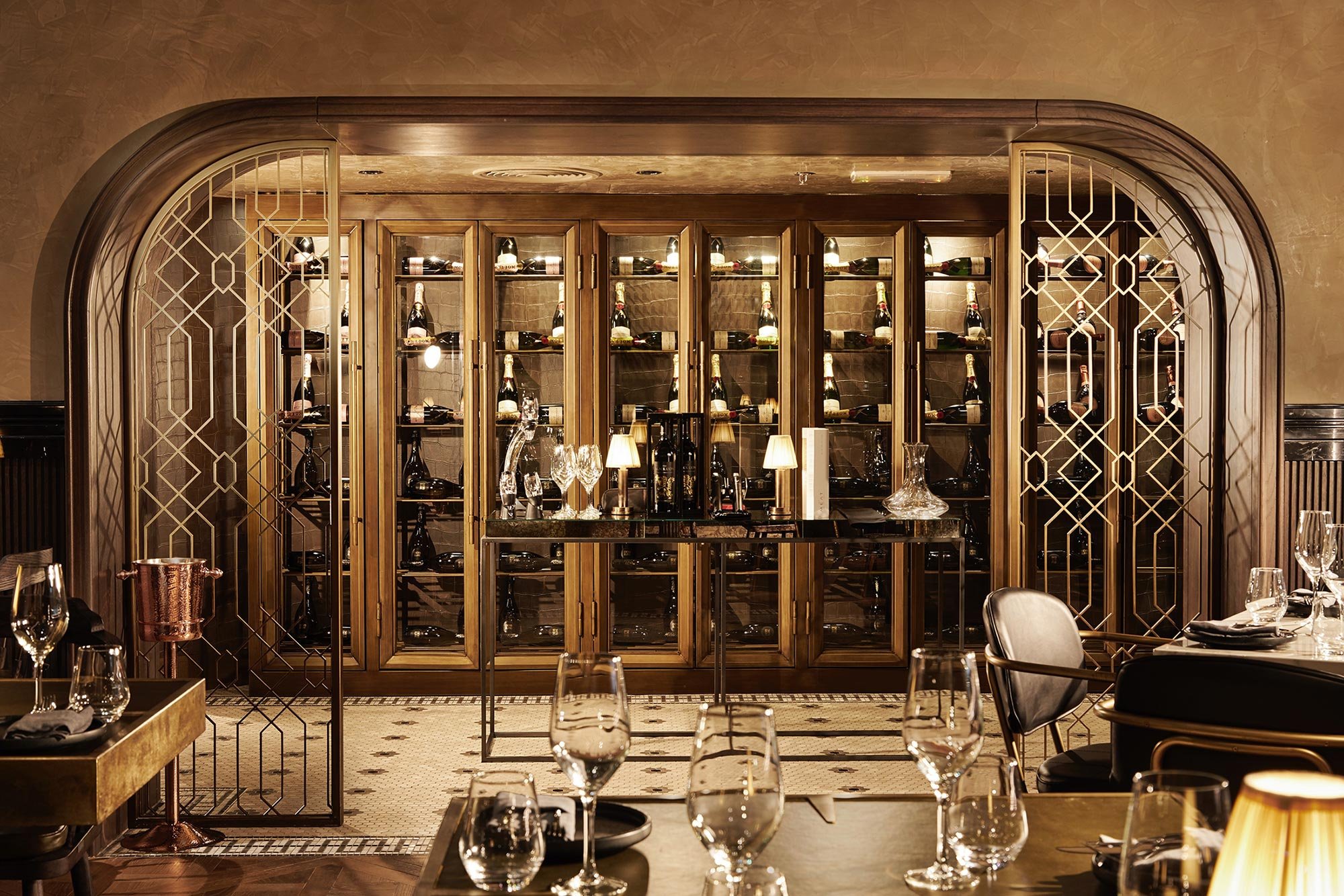 Elegant dining room with tables set with glasses, plates, and napkins