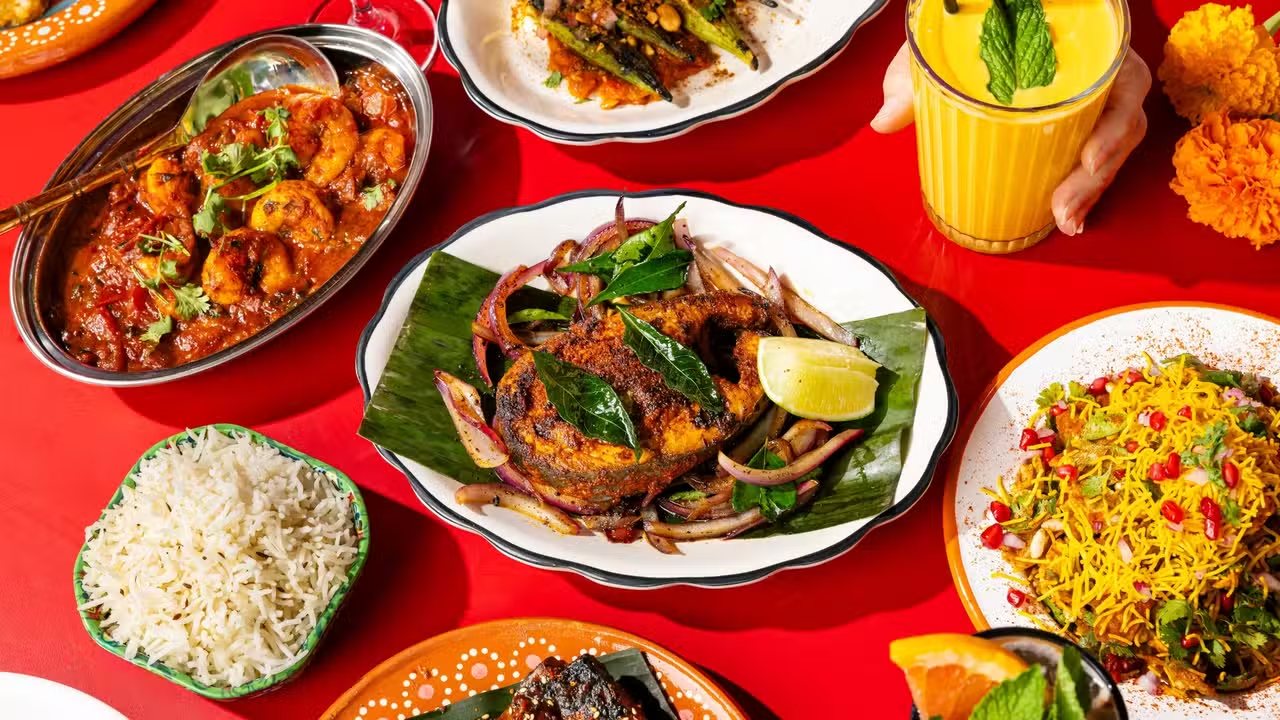 An assortment of Indian dishes on a red table