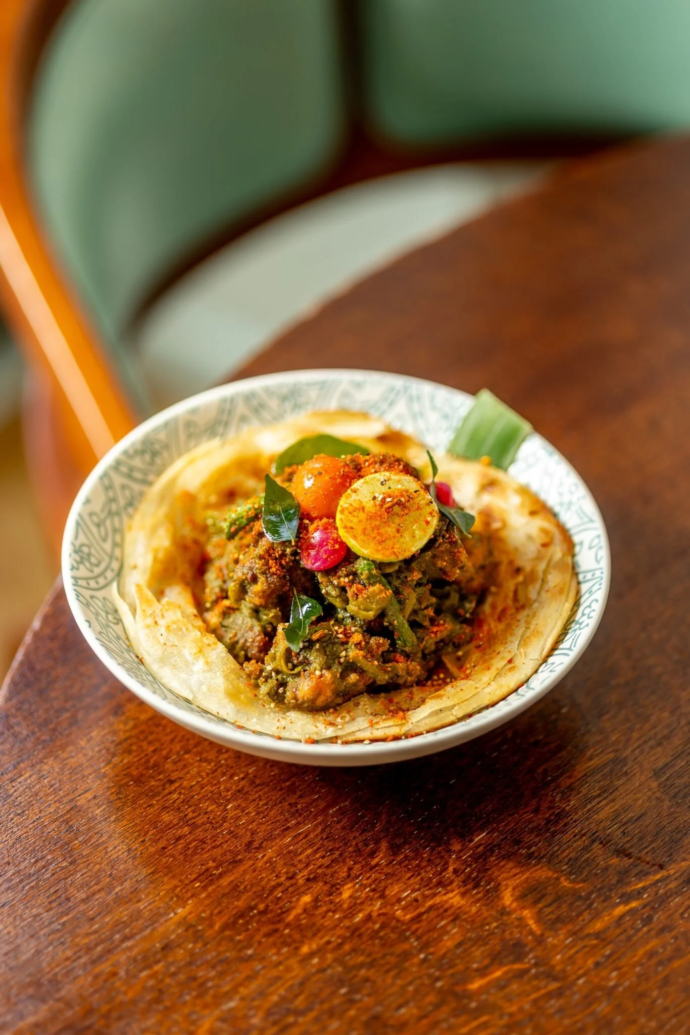 A bowl of a traditional Indian dish, possibly 'Keema', with minced meat