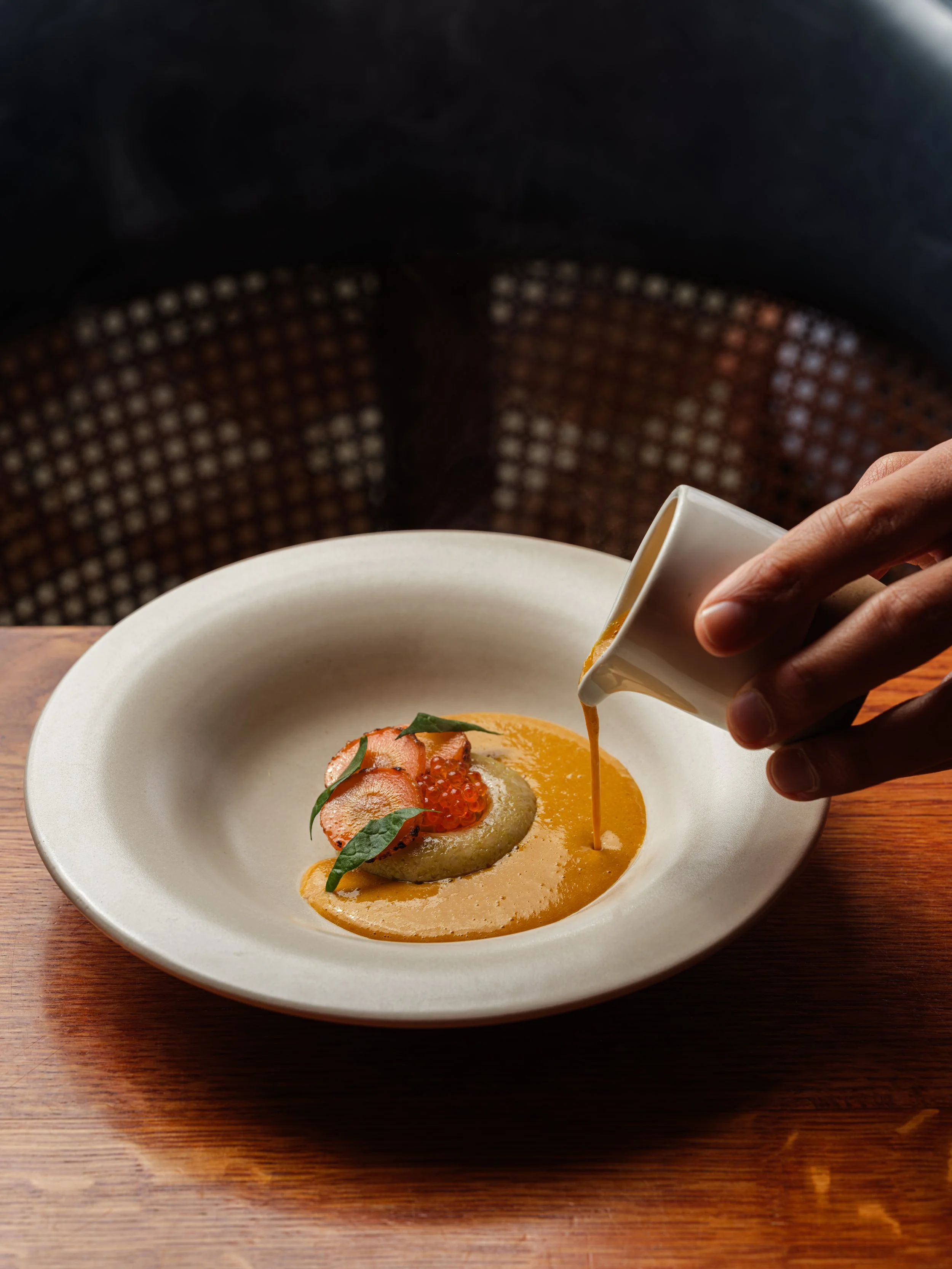 best south asian restaurant - A dish with a poached egg topped with slices of salmon cavier