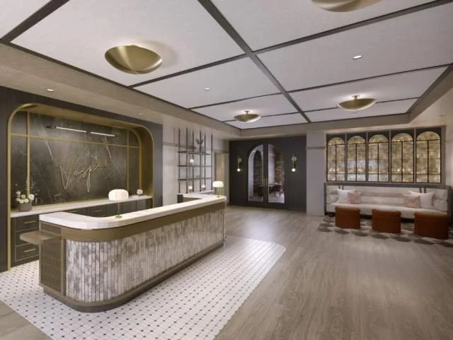 Hotel lobby with reception desk, seating area with sofas and ottomans