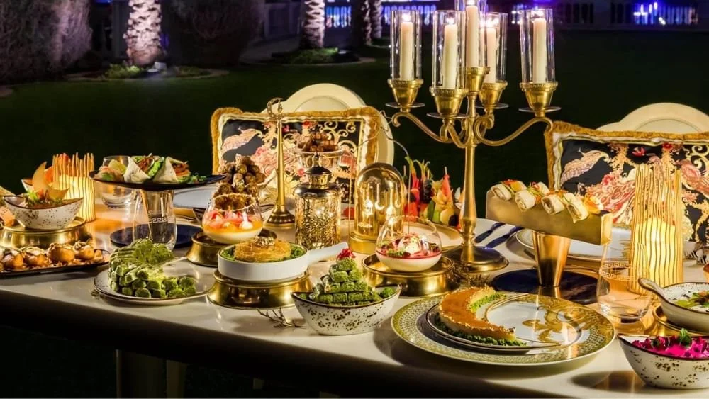 Luxurious outdoor dinner table set with various desserts, and appetizers