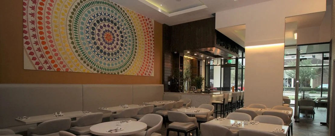 Interior of a modern restaurant with white tables and chairs
