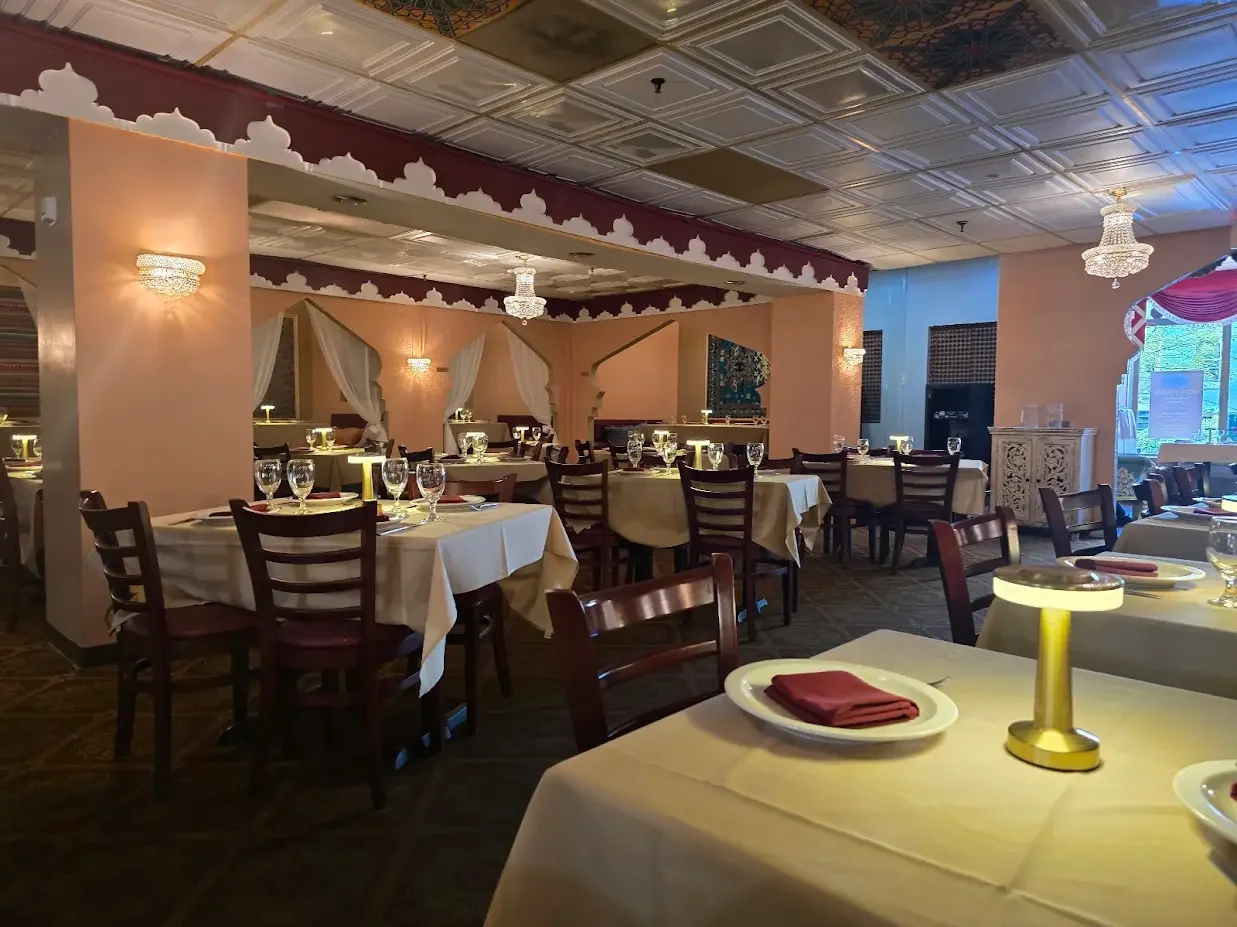 Elegant restaurant dining area with round tables, and wine glasses