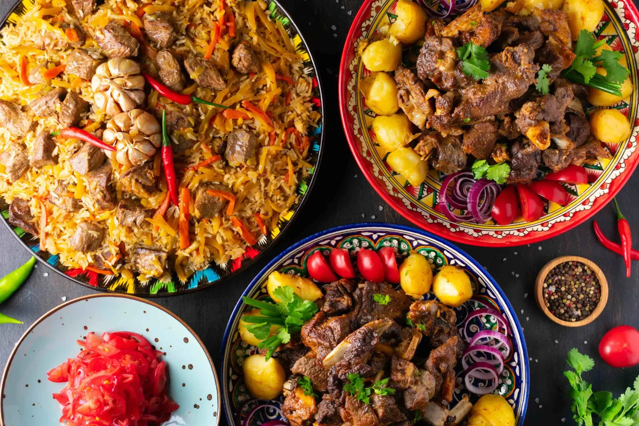 Assorted colorful dishes, including rice with vegetables and chunks of beef