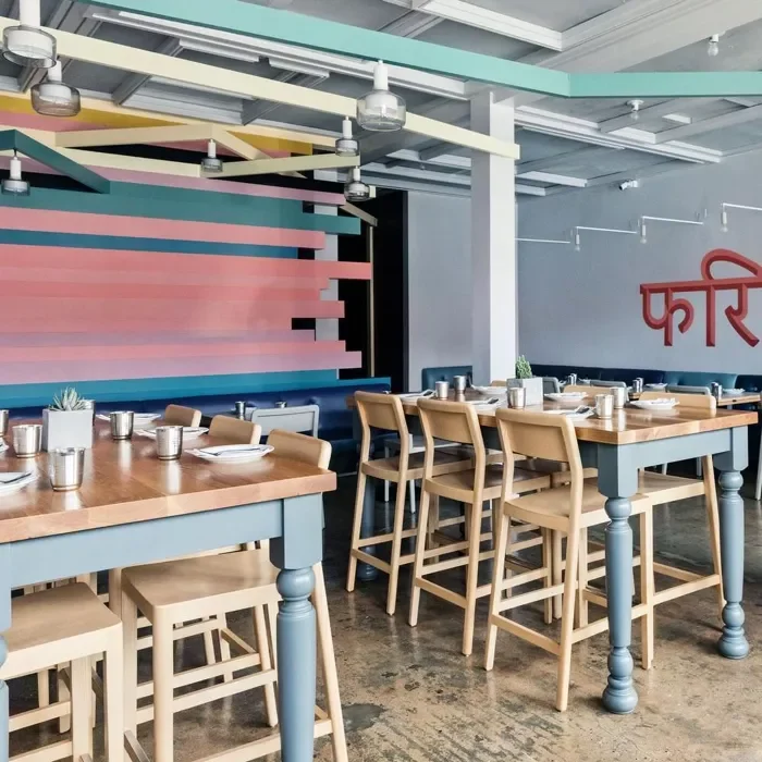 Colorful modern restaurant interior with wooden tables.