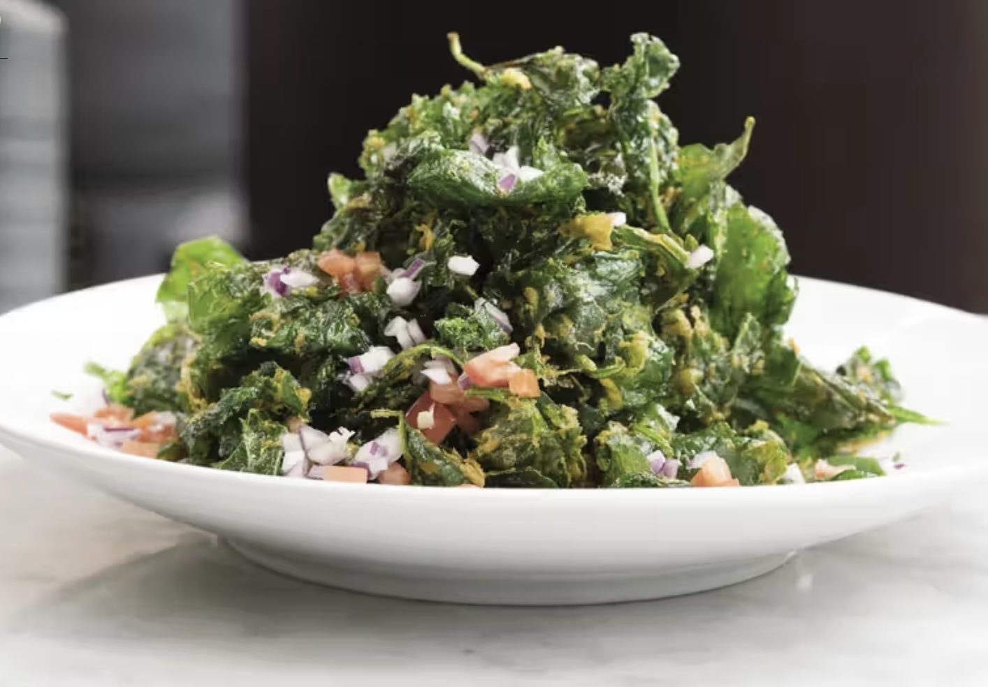 desi food reviews - a white plate of crispy spinach crisps in washington d.c.