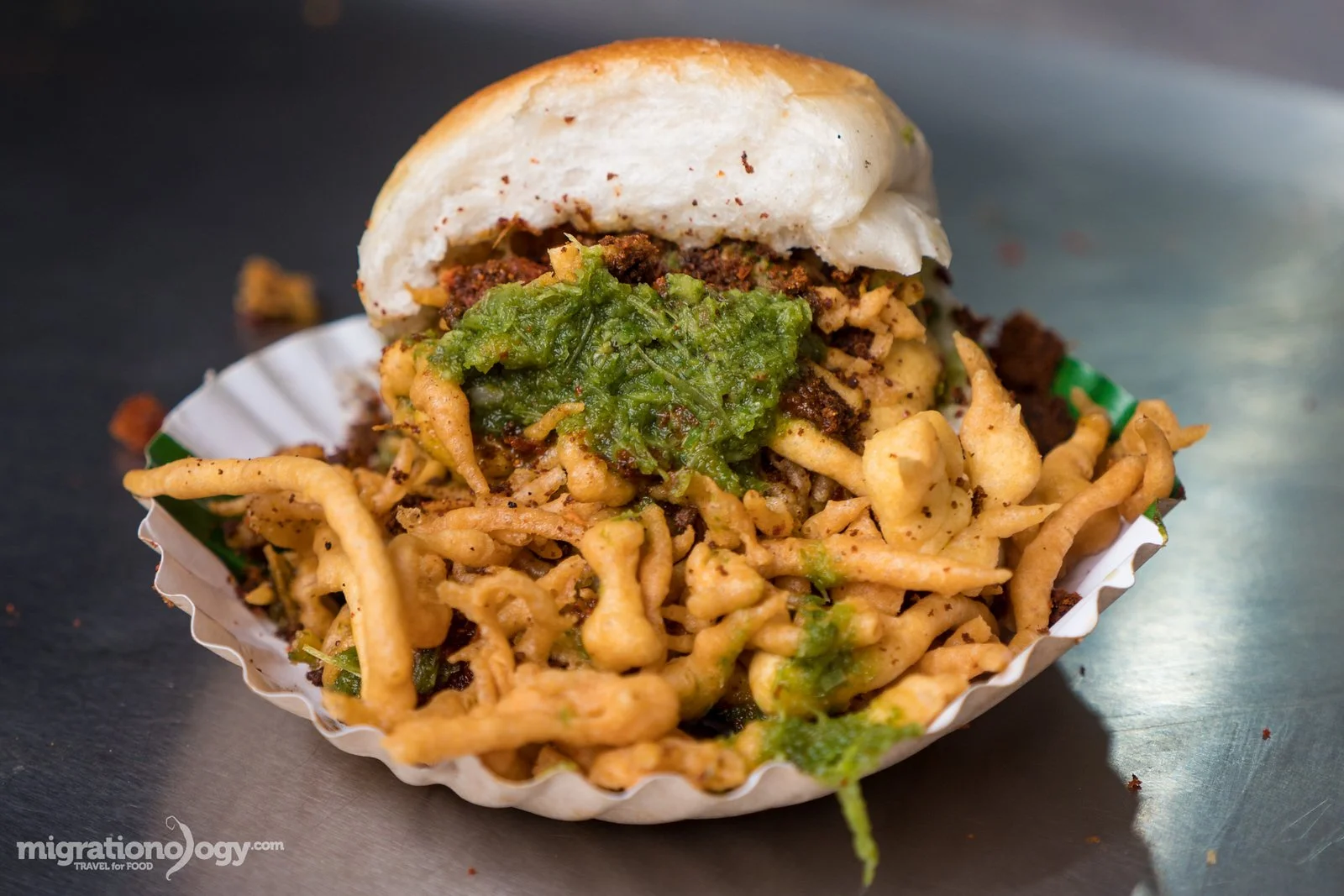 Close-up of a fried noodle dish topped with guacamole