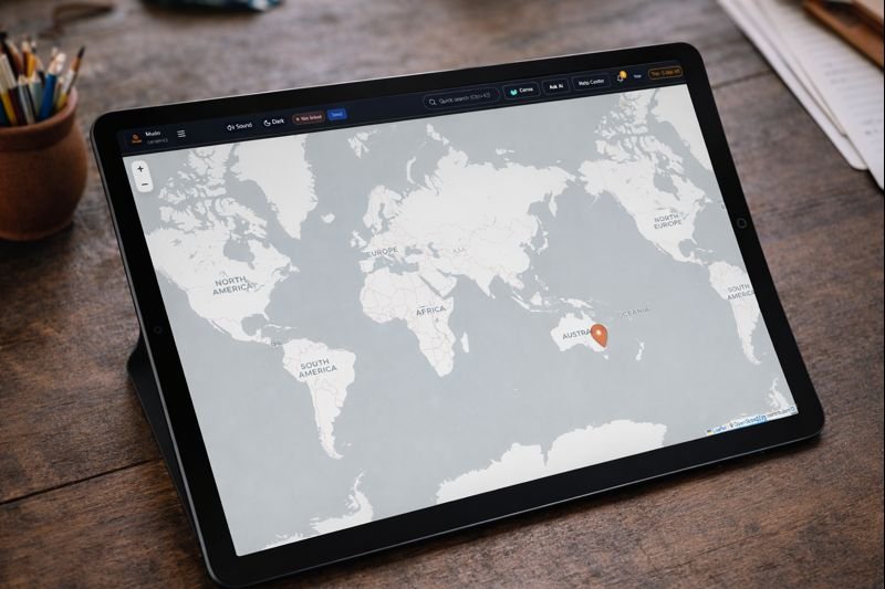 Tablet displaying a world map with a pin pointing to Australia.