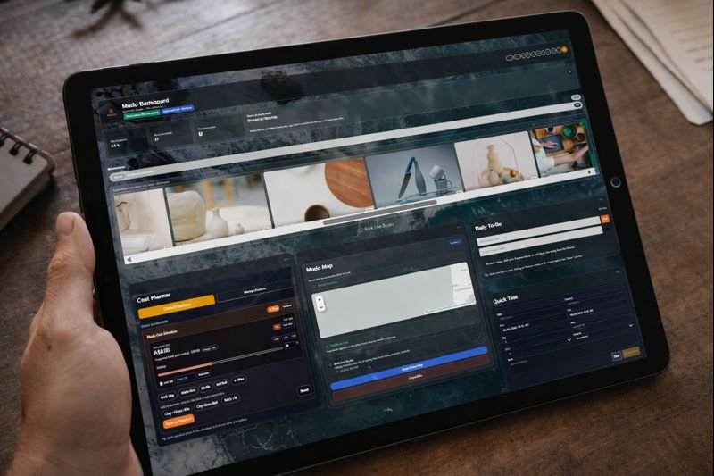 Person holding a tablet displaying a project management dashboard with charts, maps, and task lists.