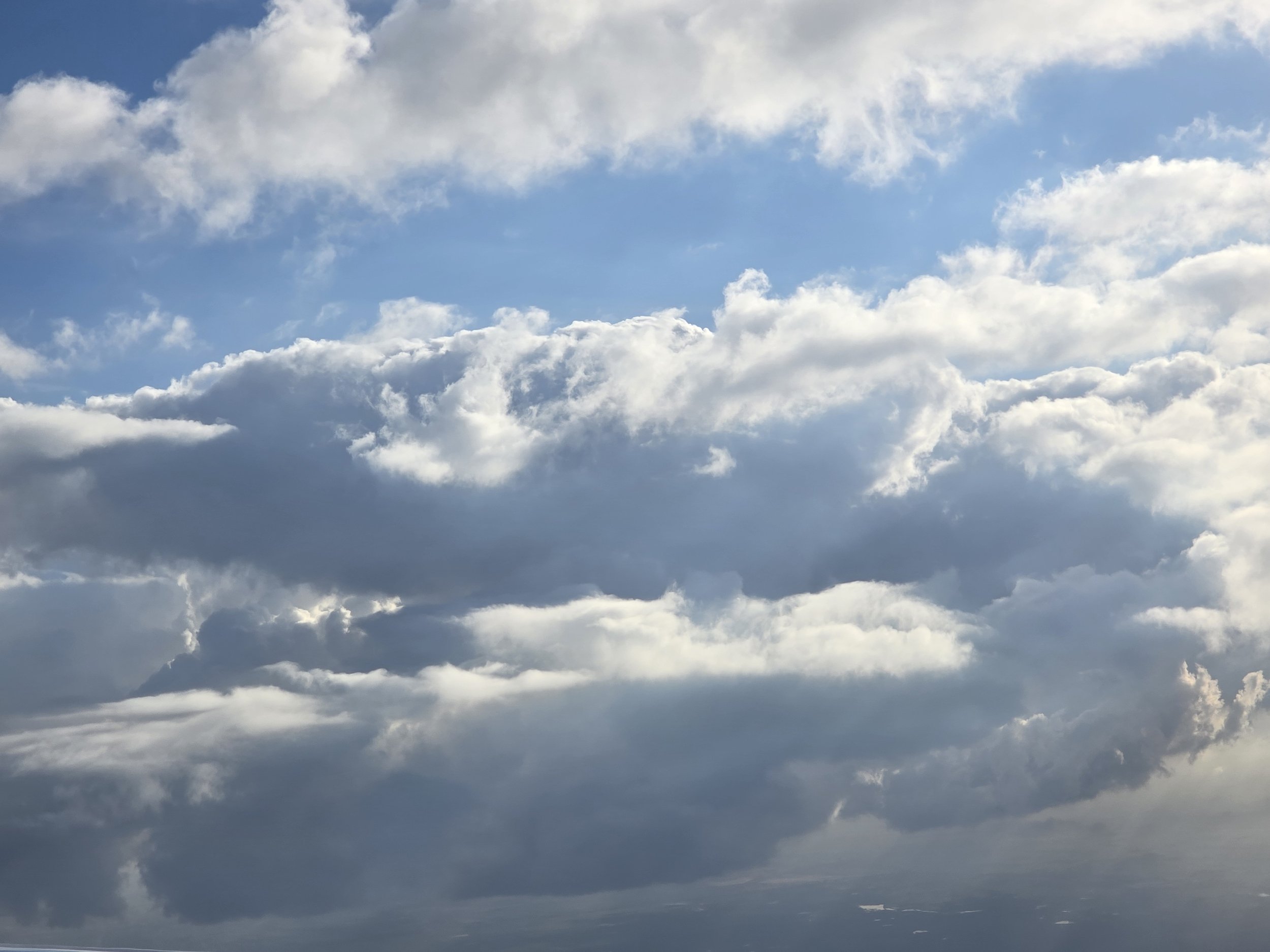 Sky filled with scattered clouds and patches of blue sky.