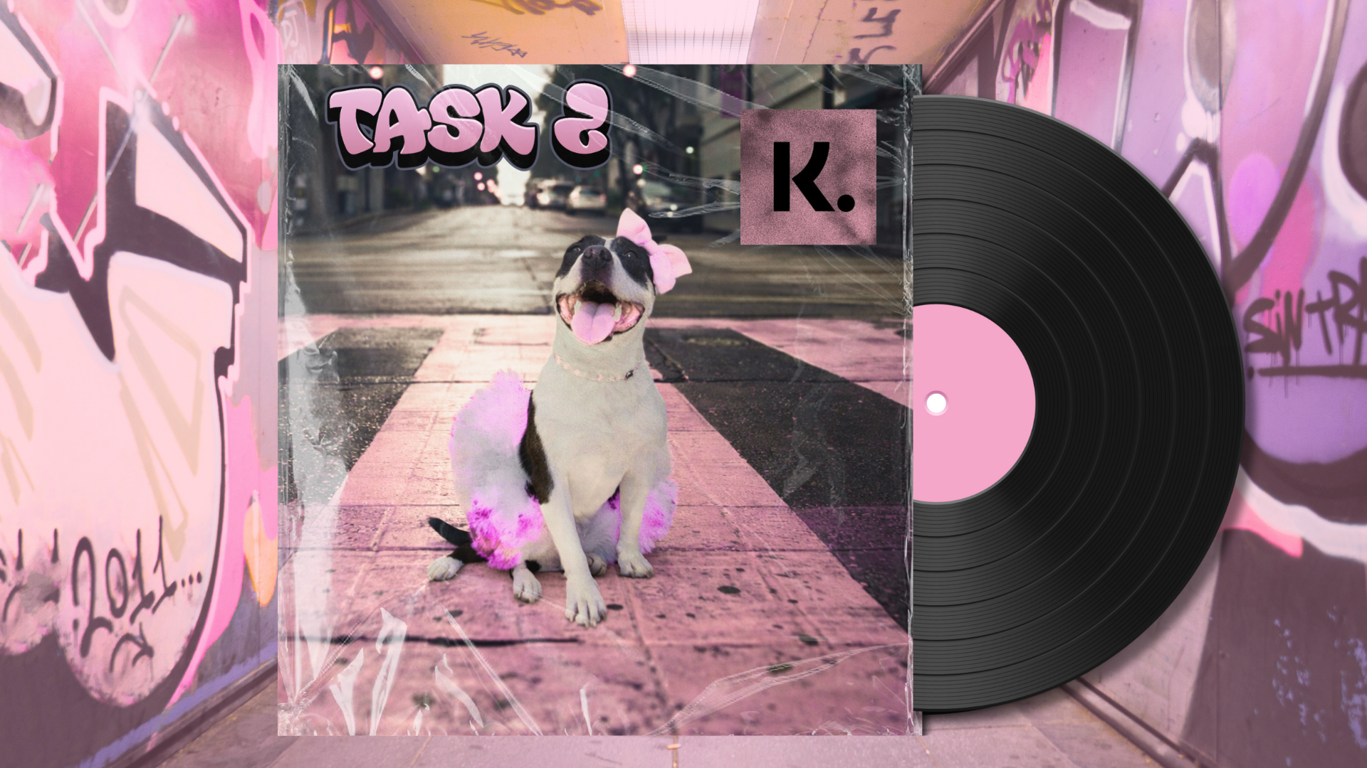 A vinyl record with pink label next to an album cover featuring a smiling dog with a pink bow, sitting on a city sidewalk with pink and purple graffiti around.
