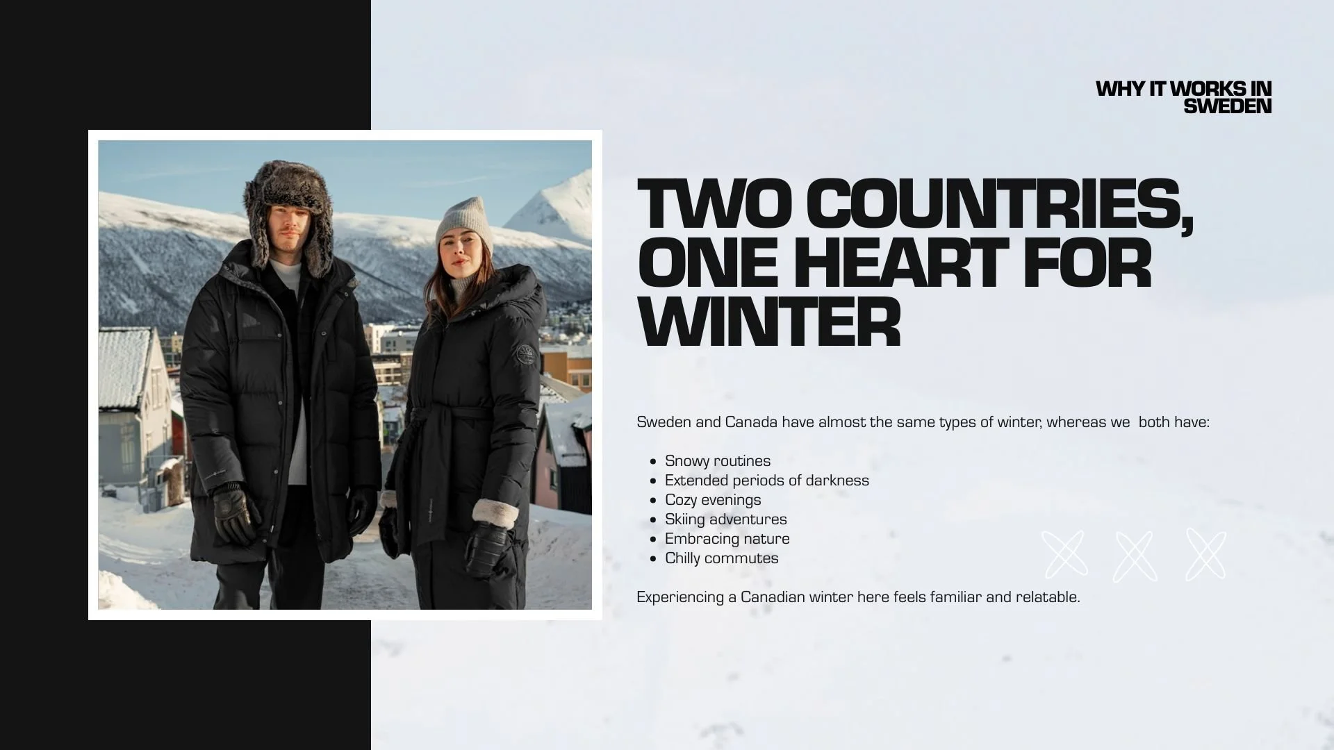 A man and woman in winter jackets standing outside in a snowy landscape with mountains in the background.