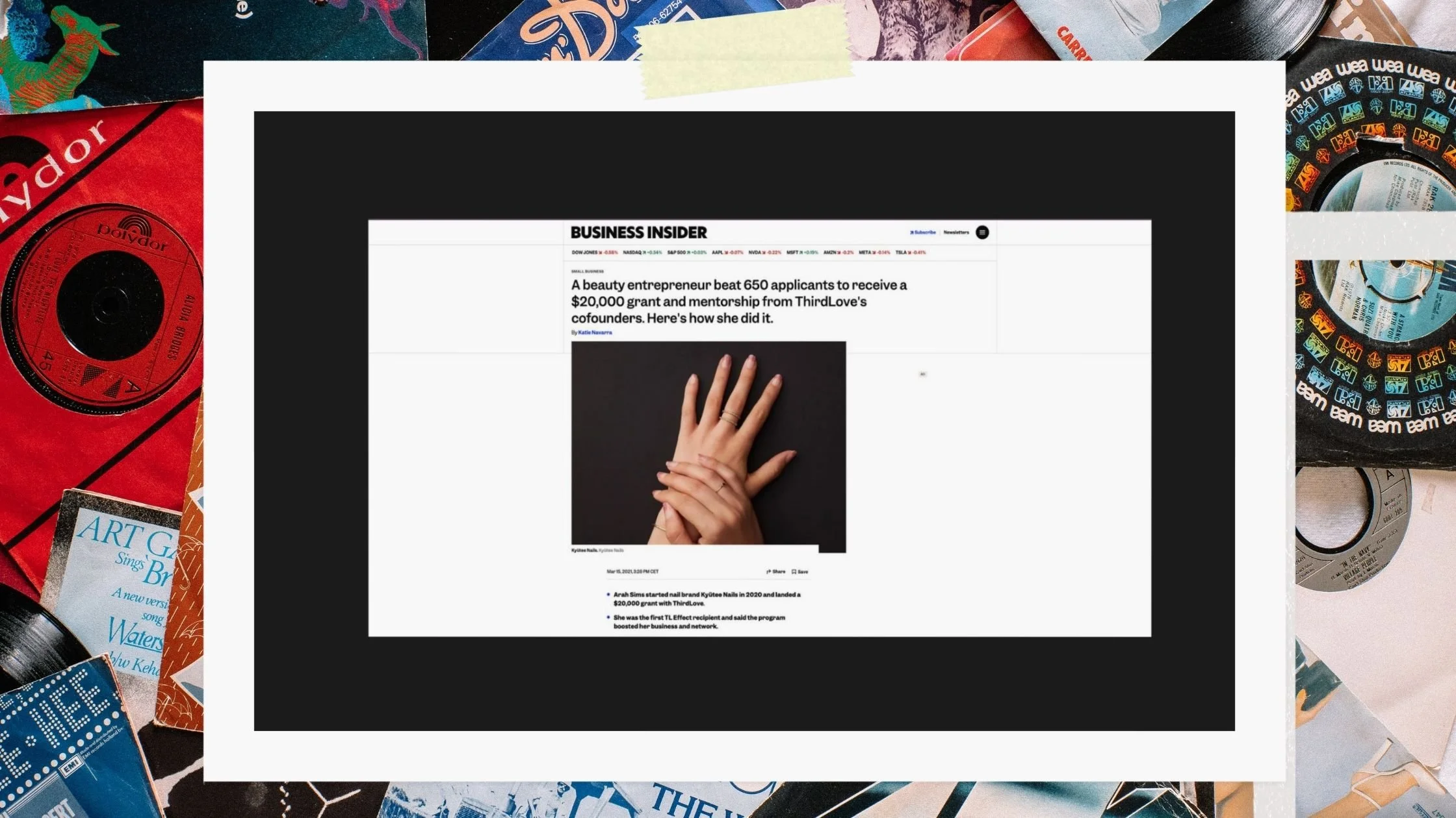 Screenshot of a news article about a beauty entrepreneur receiving a grant, with a photo of hands holding each other, surrounded by vinyl records and music album covers.