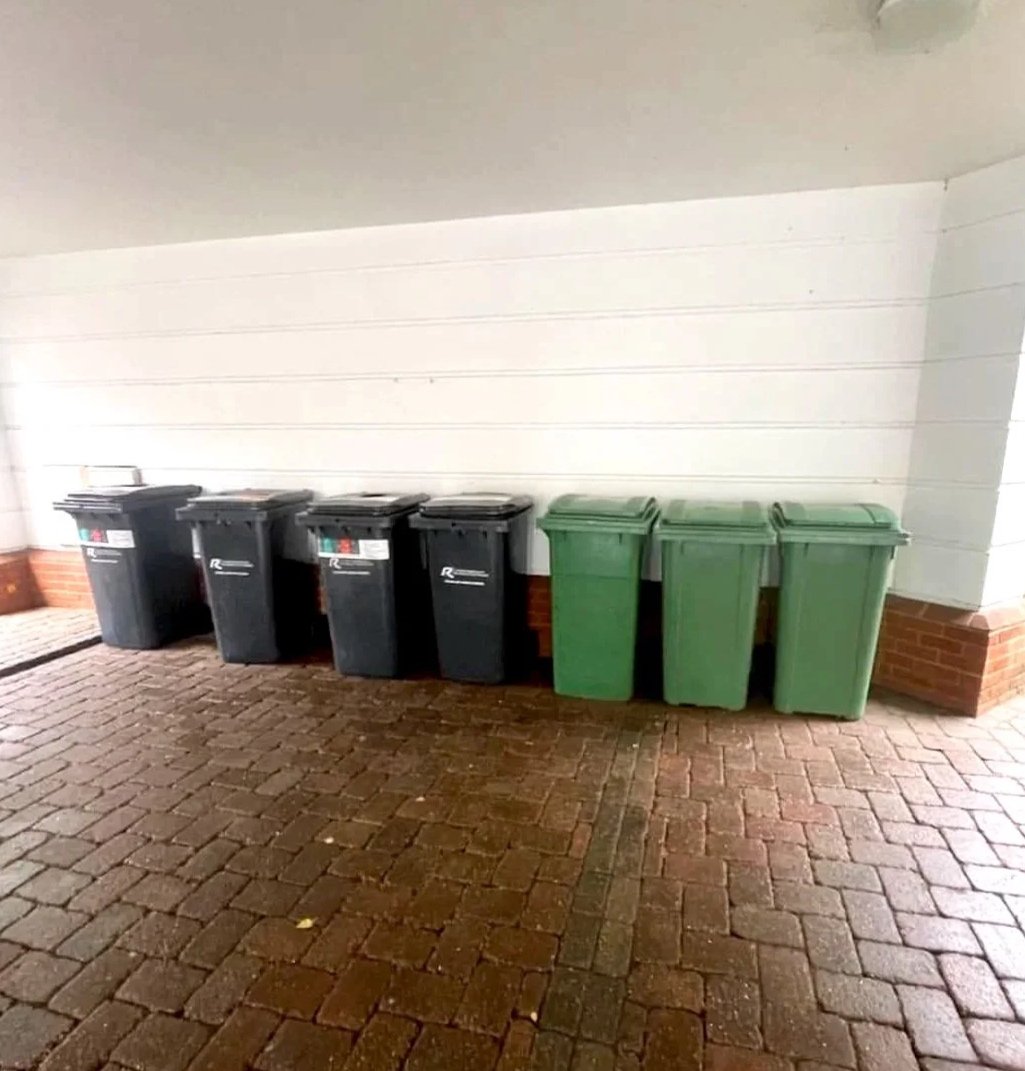 Bin store line-up after reset; waste area cleared and compliant.