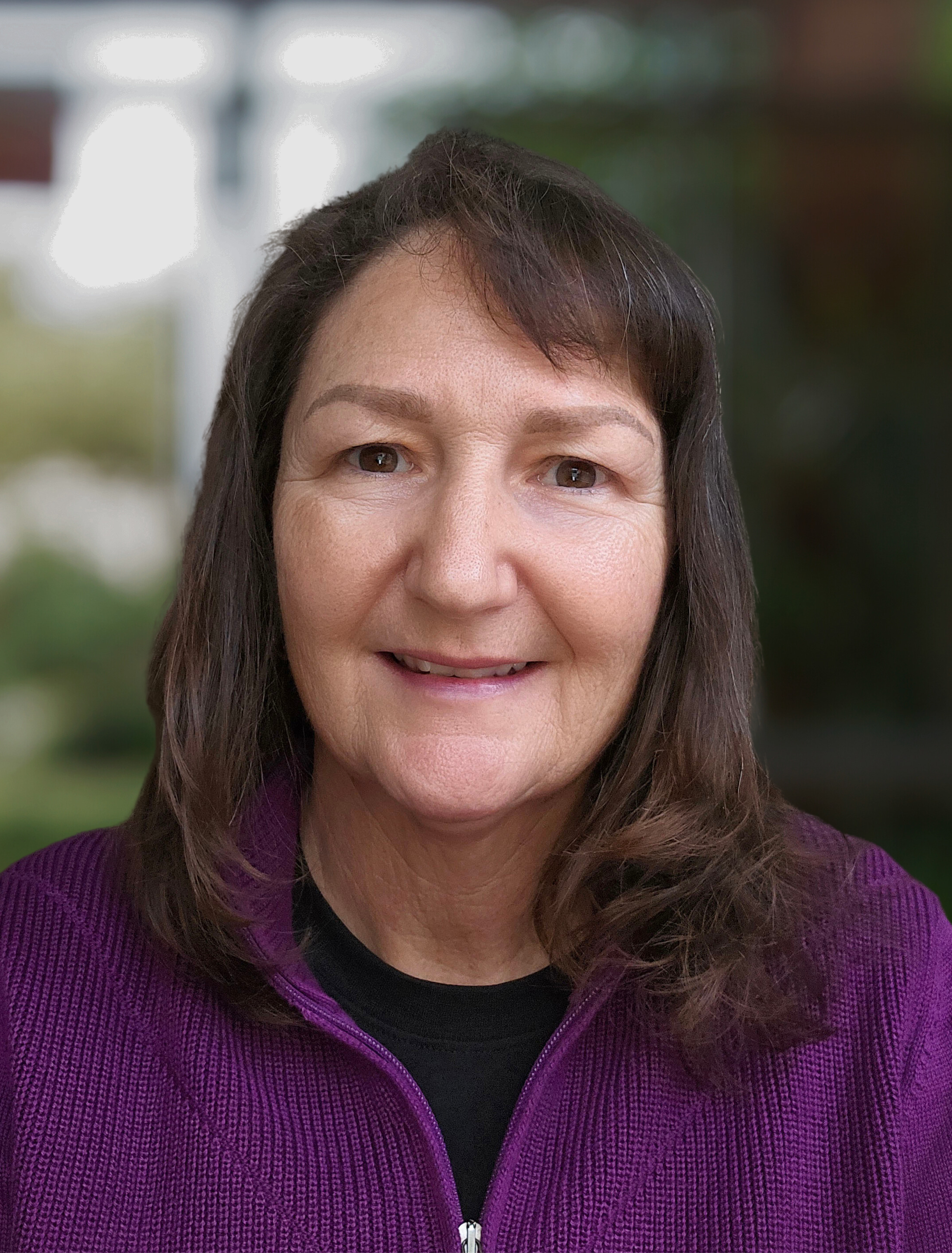 PPAO Practitioner and Co-Founder, Julie K. London in a purple sweater over a blurred background