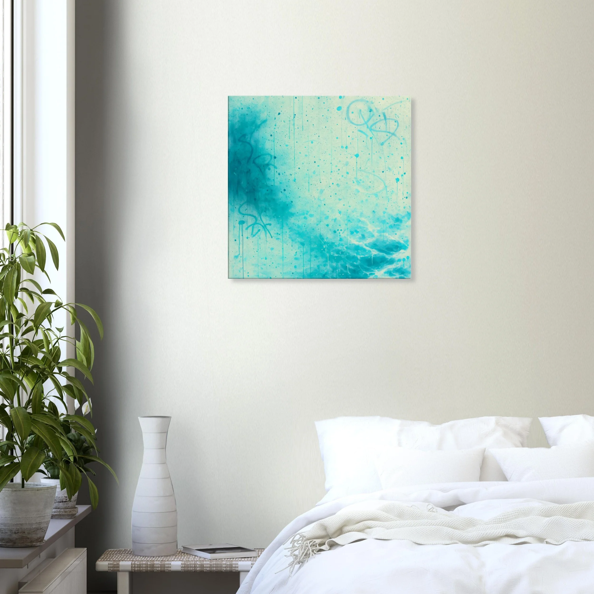 A bedroom with a white bed, white pillows, and a white blanket. There is a nightstand with a tall white vase and an open book. To the left, side of the image, is a large potted green plant. On the wall above the bed, there is an abstract blue and tea